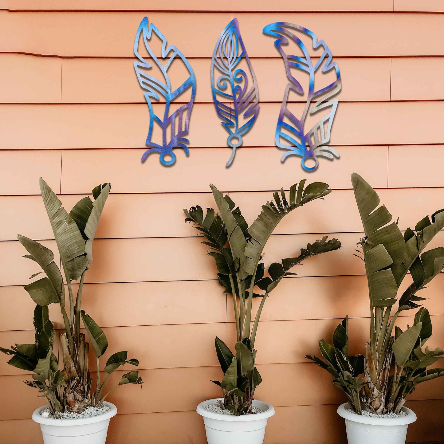 This design features three elegantly styled feathers, each with intricate patterns. The flowing lines and curved shapes give a sense of movement, making the artwork a beautiful representation of nature's delicate beauty.