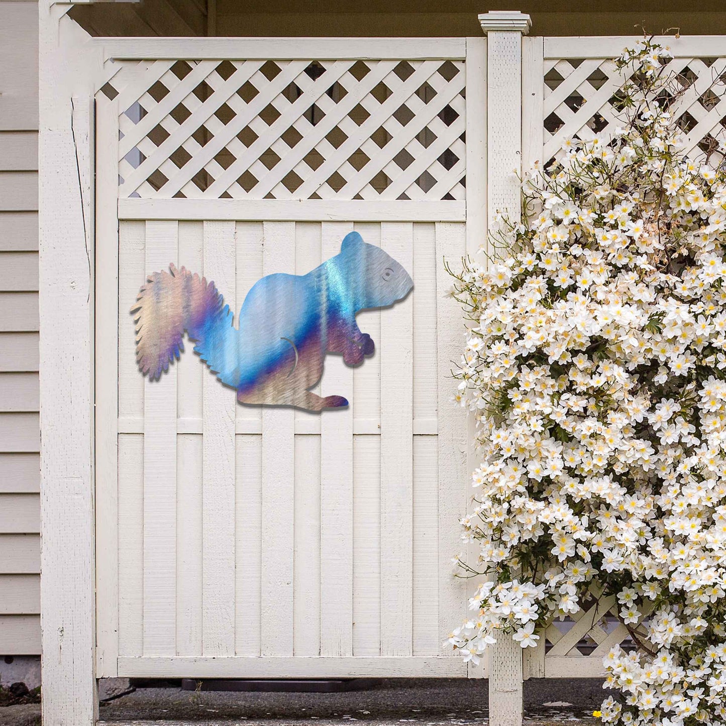 Metal garden decoration featuring a squirrel silhouette with a textured design, adding a rustic and playful accent to outdoor walls, complementing natural and minimalist garden aesthetics.