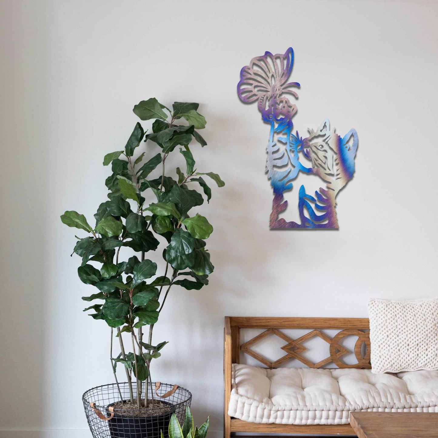 Metal wall art featuring a curious kitten playfully reaching for a butterfly, adding a delightful touch of charm and whimsy to modern indoor or outdoor decor, displayed on a neutral wall.