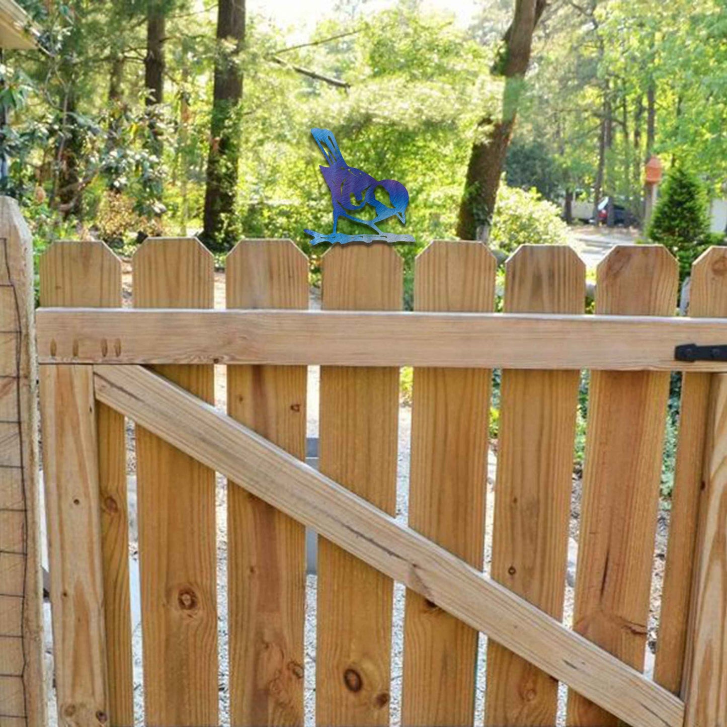 Metal garden decoration featuring a bird silhouette with a rustic finish, perched on a branch, designed to enhance fence tops or wooden posts, adding a natural and charming touch to outdoor spaces.