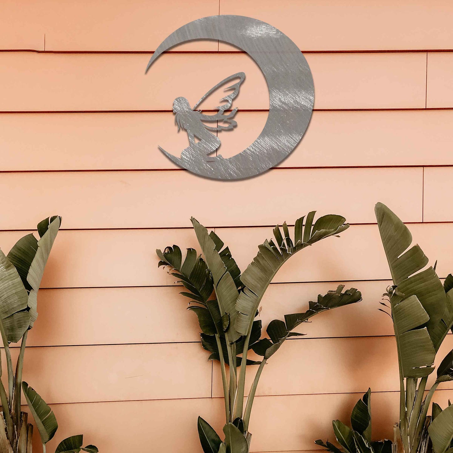 This design showcases a fairy sitting within the curve of a crescent moon, adding a mystical touch with delicate wings. The flowing, simple lines of the crescent and the fairy's posture create a peaceful, ethereal feeling, perfect for enhancing a serene space.