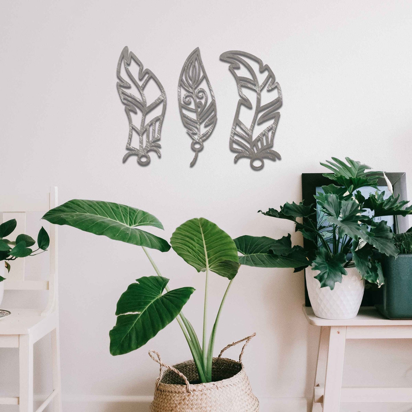 This design features three elegantly styled feathers, each with intricate patterns. The flowing lines and curved shapes give a sense of movement, making the artwork a beautiful representation of nature's delicate beauty.