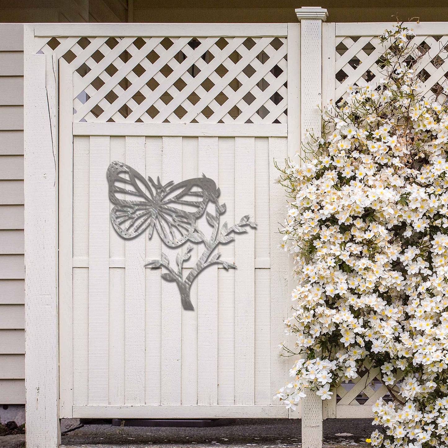 Metal garden decoration featuring a butterfly resting on a leafy branch, crafted with intricate detailing to bring a touch of nature-inspired elegance and charm to outdoor walls or garden settings.