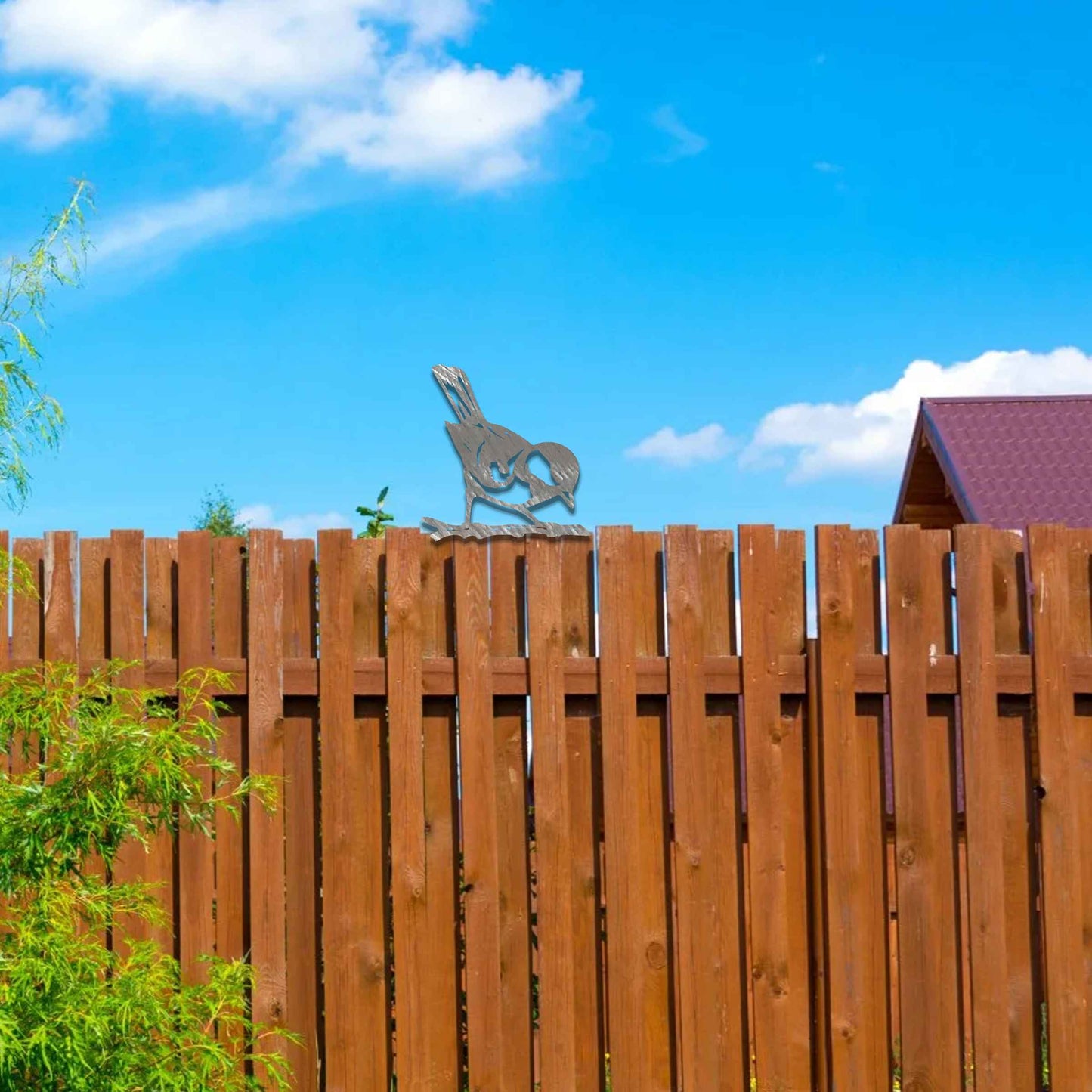 Metal garden decoration featuring a bird silhouette with a rustic finish, perched on a branch, designed to enhance fence tops or wooden posts, adding a natural and charming touch to outdoor spaces.