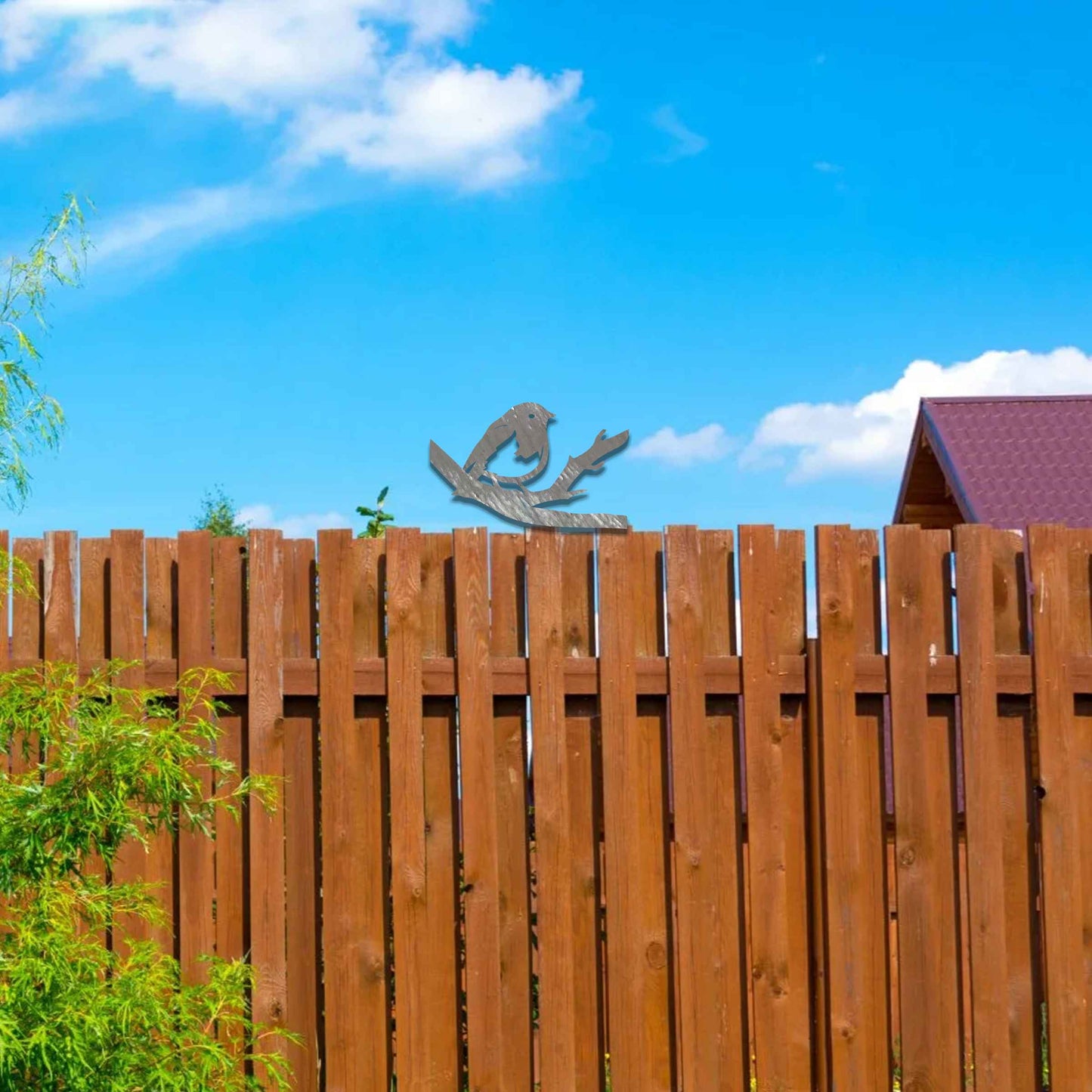 Metal garden decoration featuring a bird perched on a branch with intricate cutout details and a rustic finish, designed to adorn wooden posts or beams, adding a charming and natural accent to outdoor spaces.