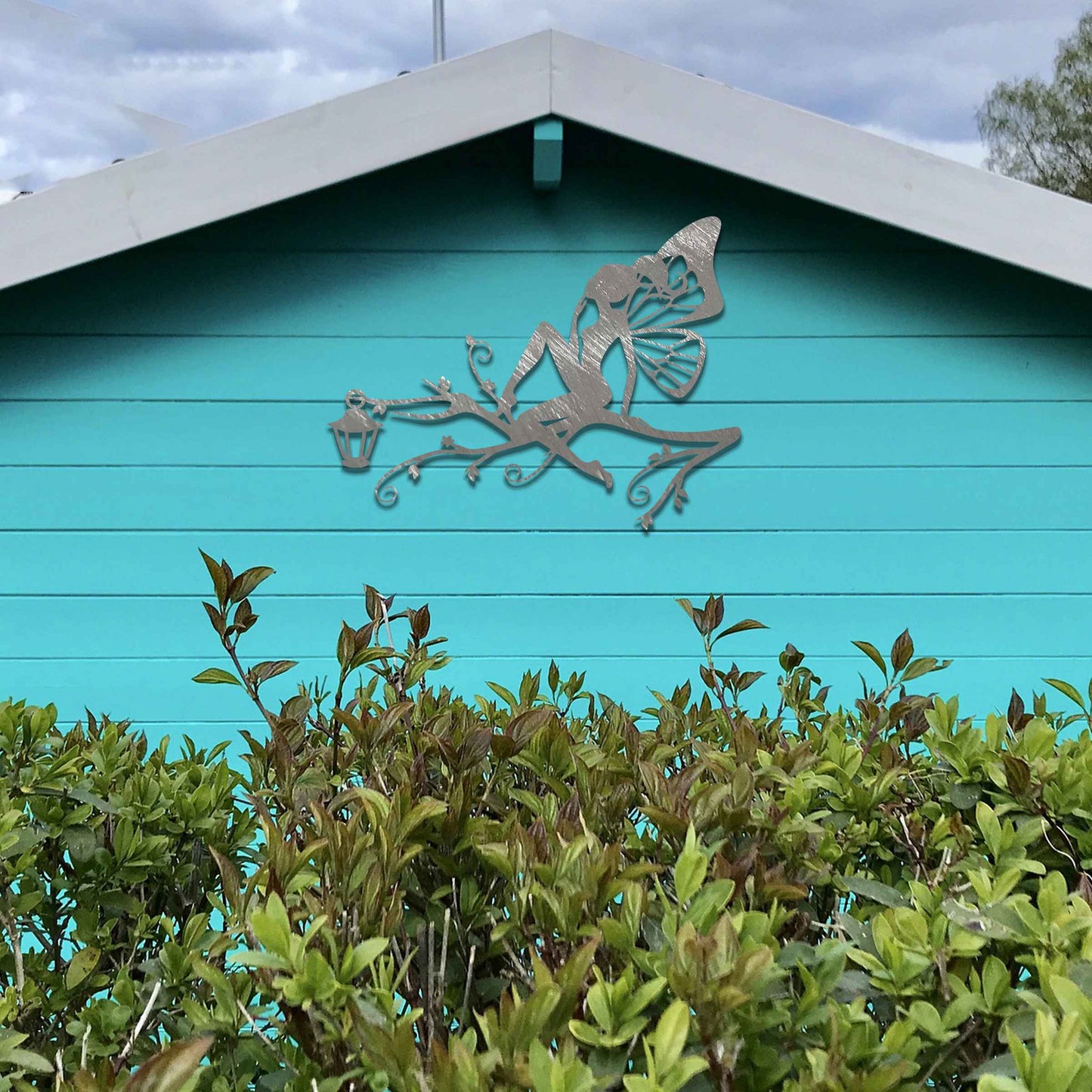 This design features a fairy seated elegantly on a tree branch with intricate vines, accompanied by a charming lantern. The detailed wings and graceful pose of the fairy add a magical, whimsical touch to the piece.