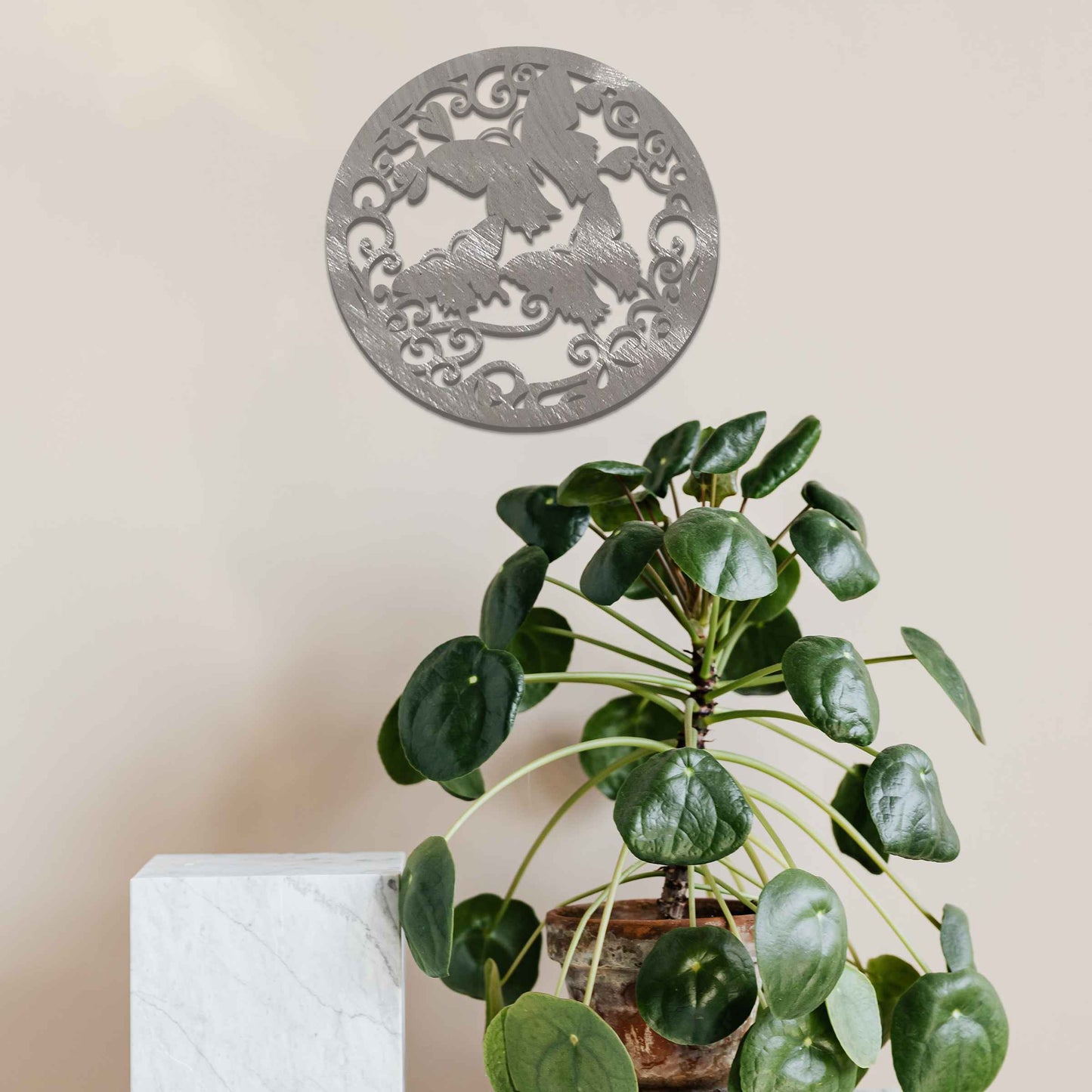 Metal garden decoration featuring a circular design with intricate butterflies and swirling vine patterns, adding a touch of elegance and nature-inspired artistry to outdoor or indoor spaces.