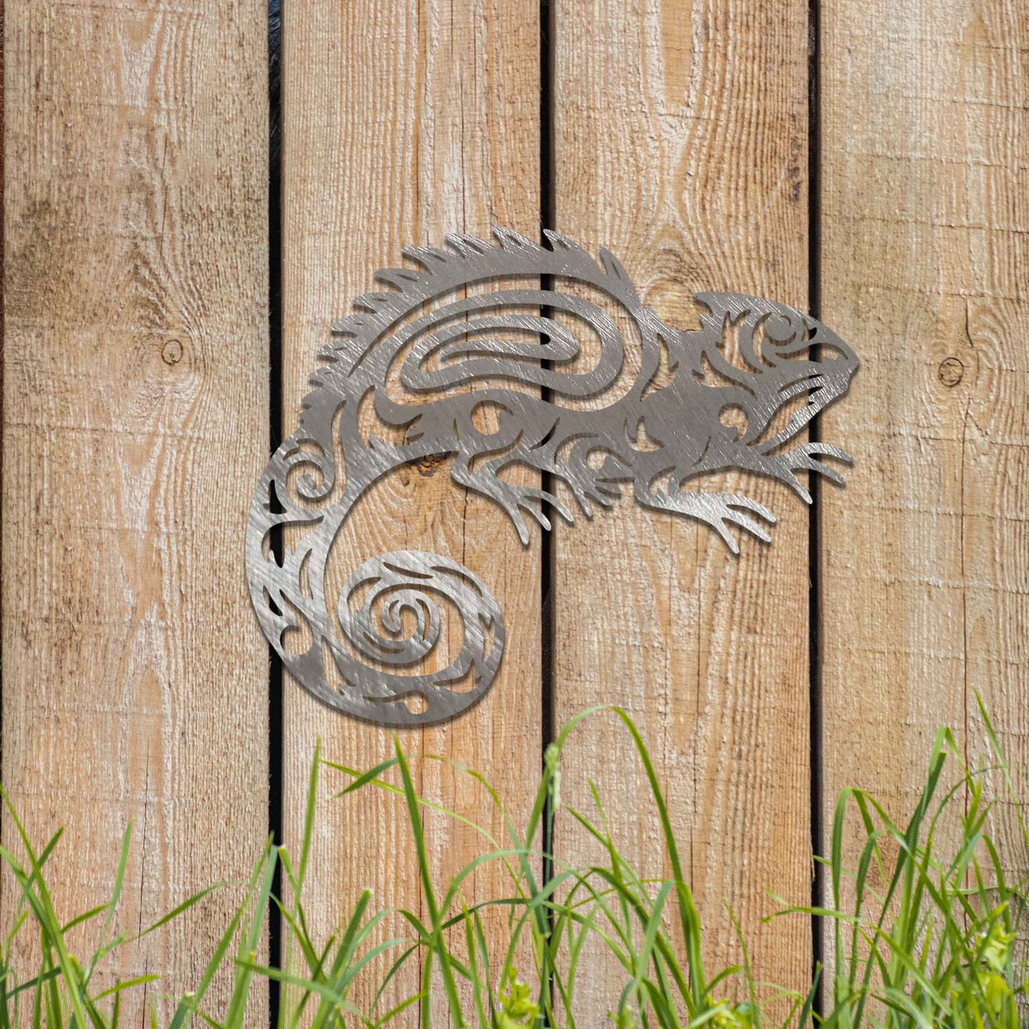 Metal wall decoration featuring a chameleon design with intricate tribal-inspired cutouts, adding an exotic and artistic touch to indoor spaces, displayed on a neutral wall in modern decor.
