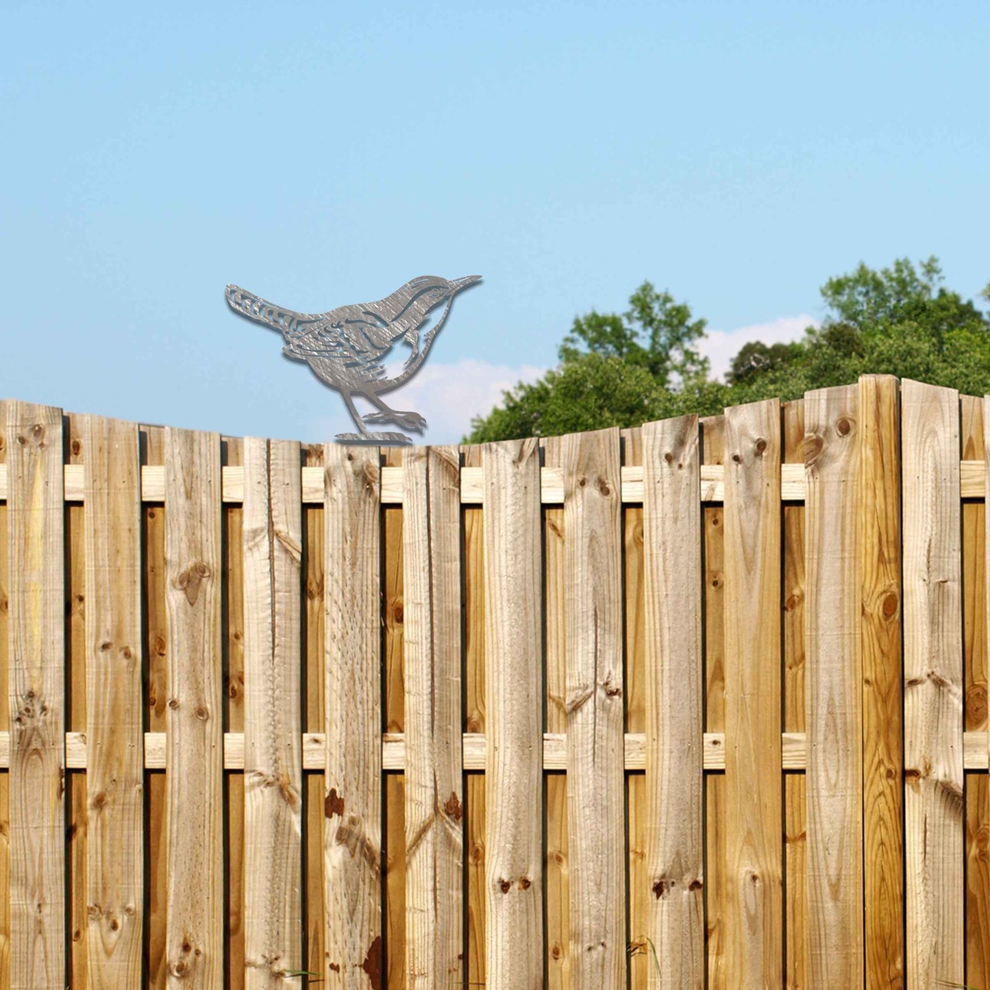 Metal garden decoration featuring a wren silhouette with intricate cutout details and a rustic finish, designed to sit atop fences or posts, adding a delicate and natural charm to outdoor spaces.