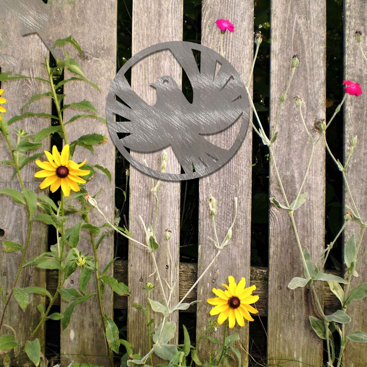 Metal garden decoration featuring a dove silhouette within a circular frame, crafted with minimalist yet elegant detailing, symbolising peace and adding a refined artistic touch to outdoor walls or fences.