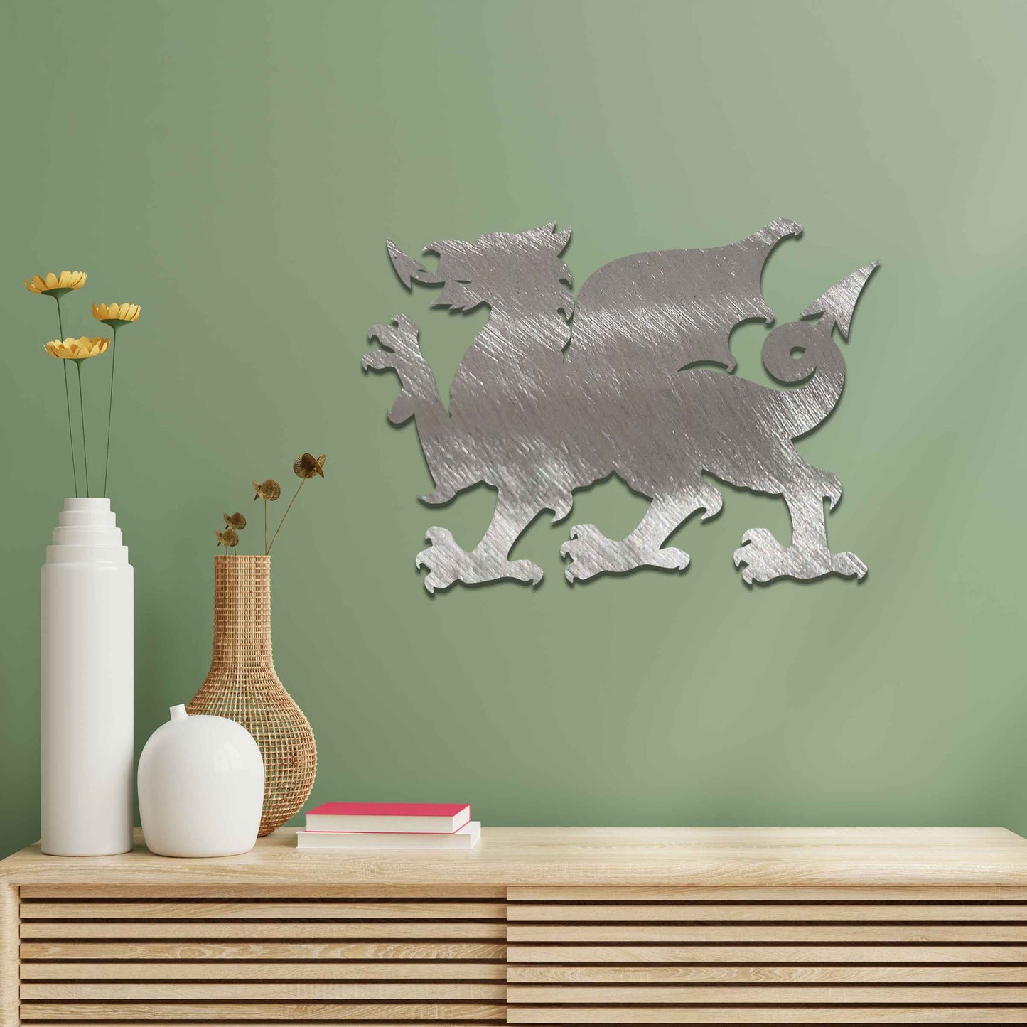 This image features the Welsh dragon, an iconic and powerful symbol of Wales. The design emphasizes the dragon’s fierce stance, with detailed wings, sharp claws, and an arched tail. Its strong profile is bold, representing strength and heritage, while the rustic, weathered finish gives the artwork a timeless, historic feel.