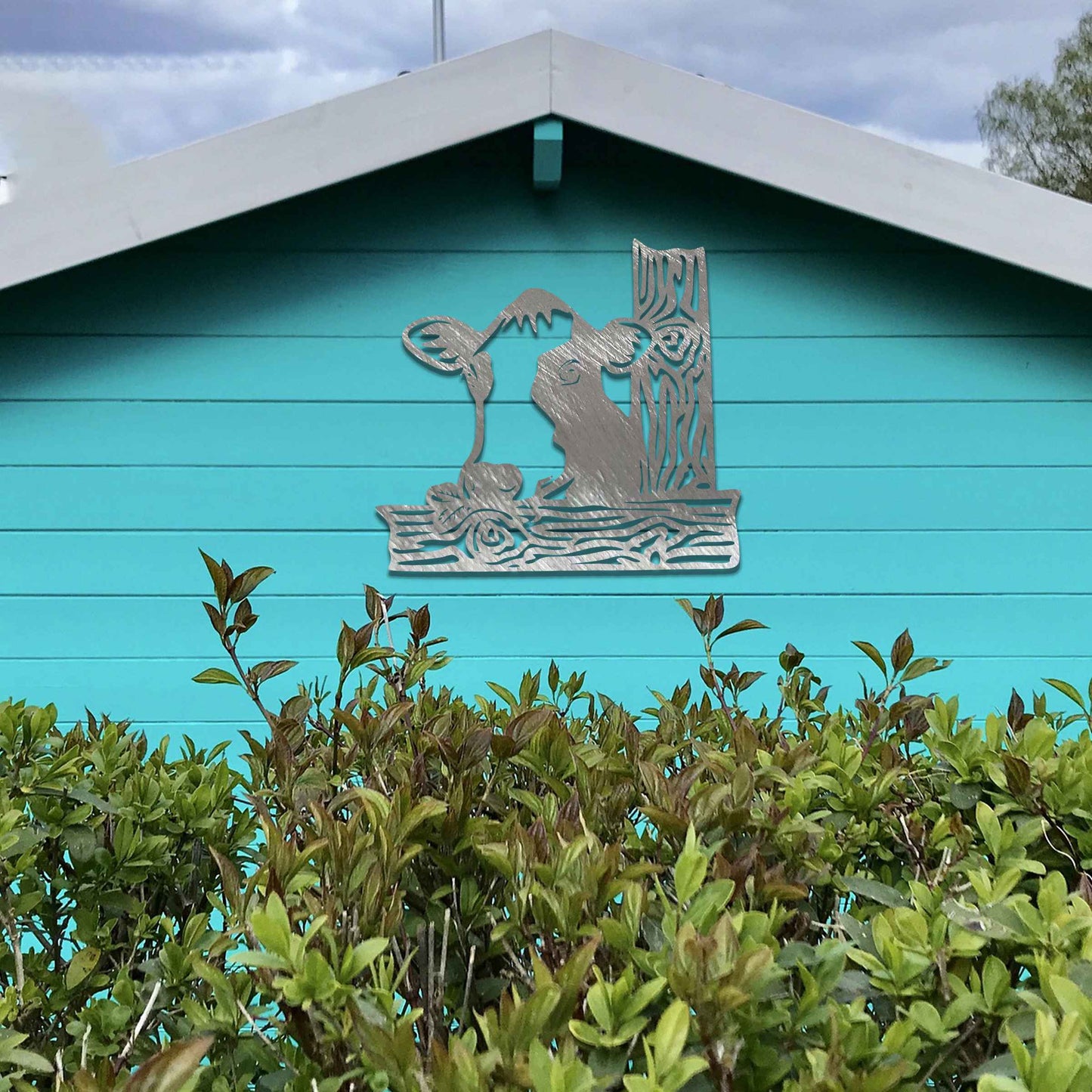 The design features a cow's head peeking over a wooden fence. The cow is drawn with distinct lines, giving it a playful and curious look. The stylized wooden posts complement the cow’s design, adding depth and structure.
