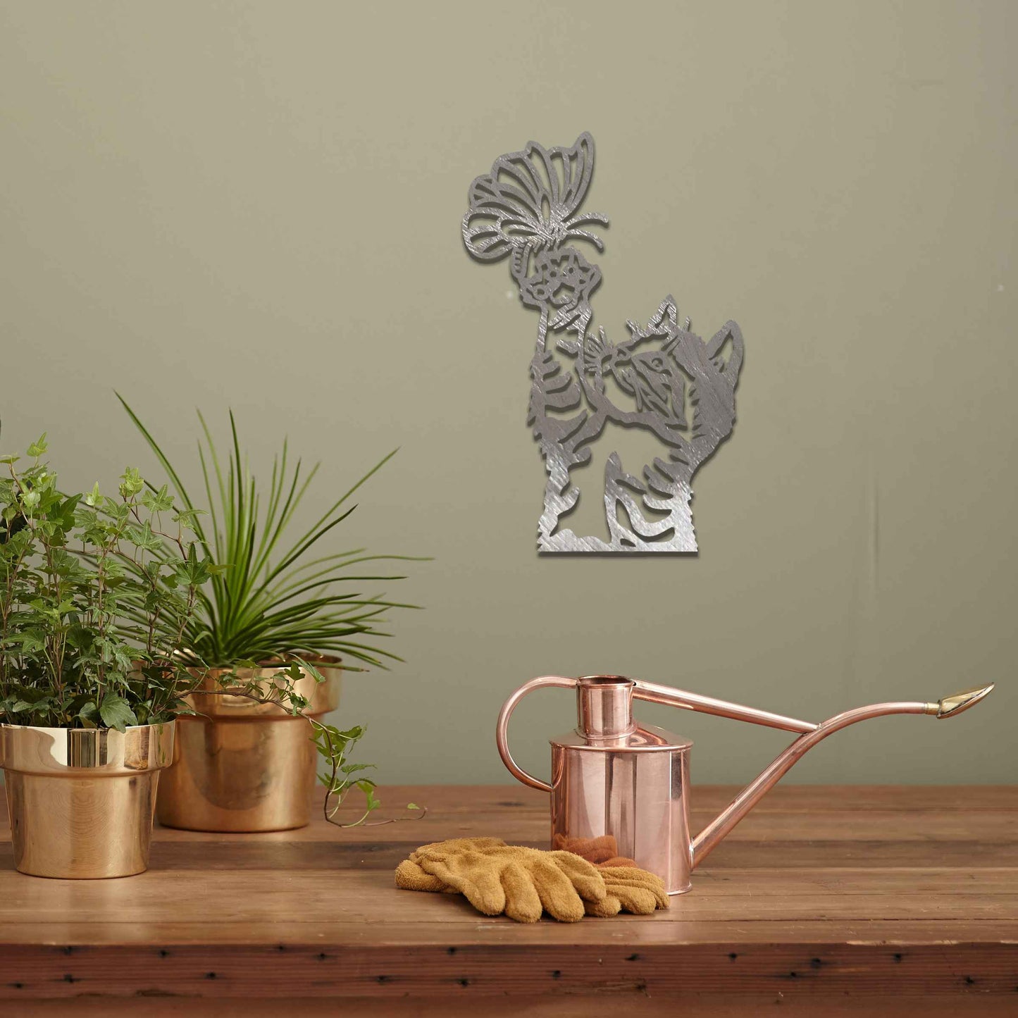Metal wall art featuring a curious kitten playfully reaching for a butterfly, adding a delightful touch of charm and whimsy to modern indoor or outdoor decor, displayed on a neutral wall.