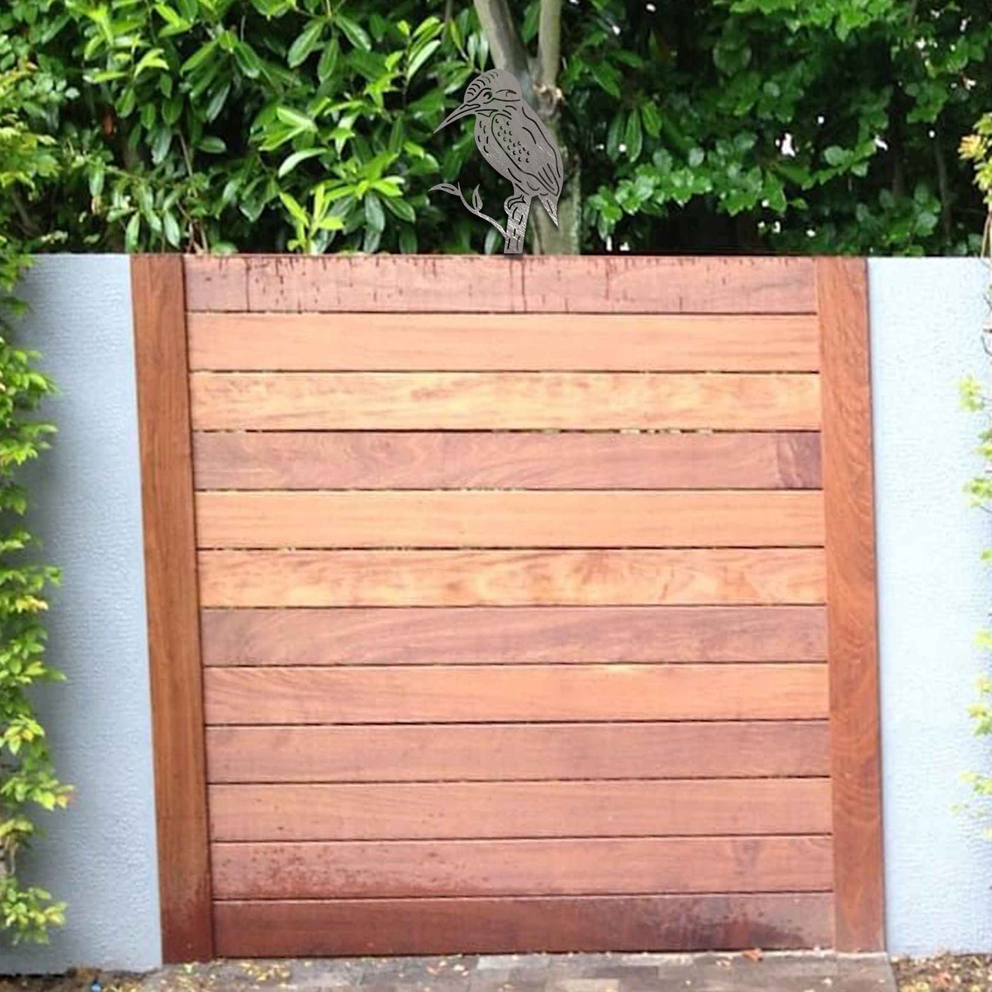 Metal garden decoration featuring a kingfisher silhouette perched on a branch, crafted with a rustic finish, designed to sit atop fences or garden posts, adding a natural and artistic accent to outdoor spaces.