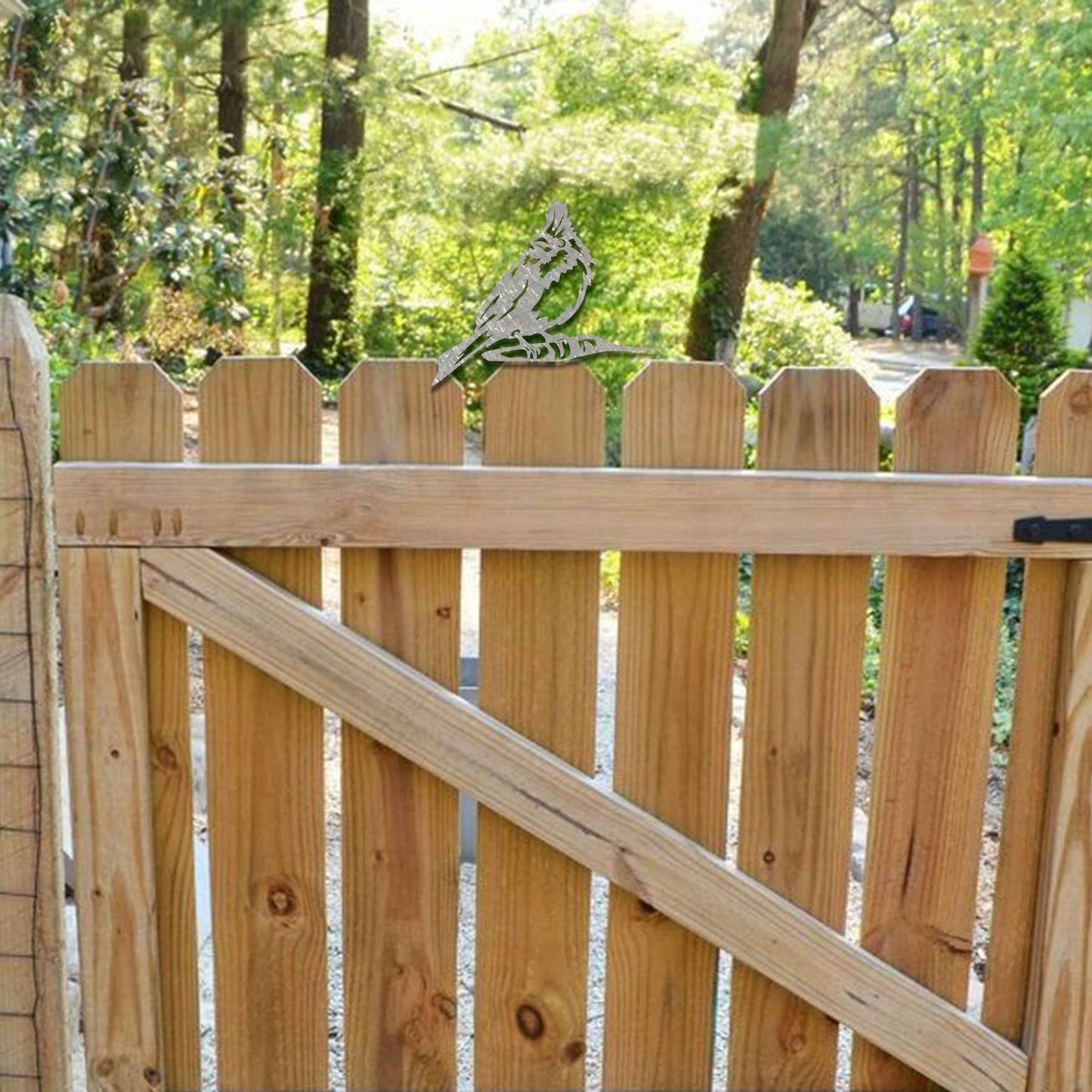 Metal garden decoration featuring a hoopoe bird silhouette with intricate cutout details and a rustic finish, designed to sit atop fences or posts, adding a distinctive and elegant touch to outdoor spaces.