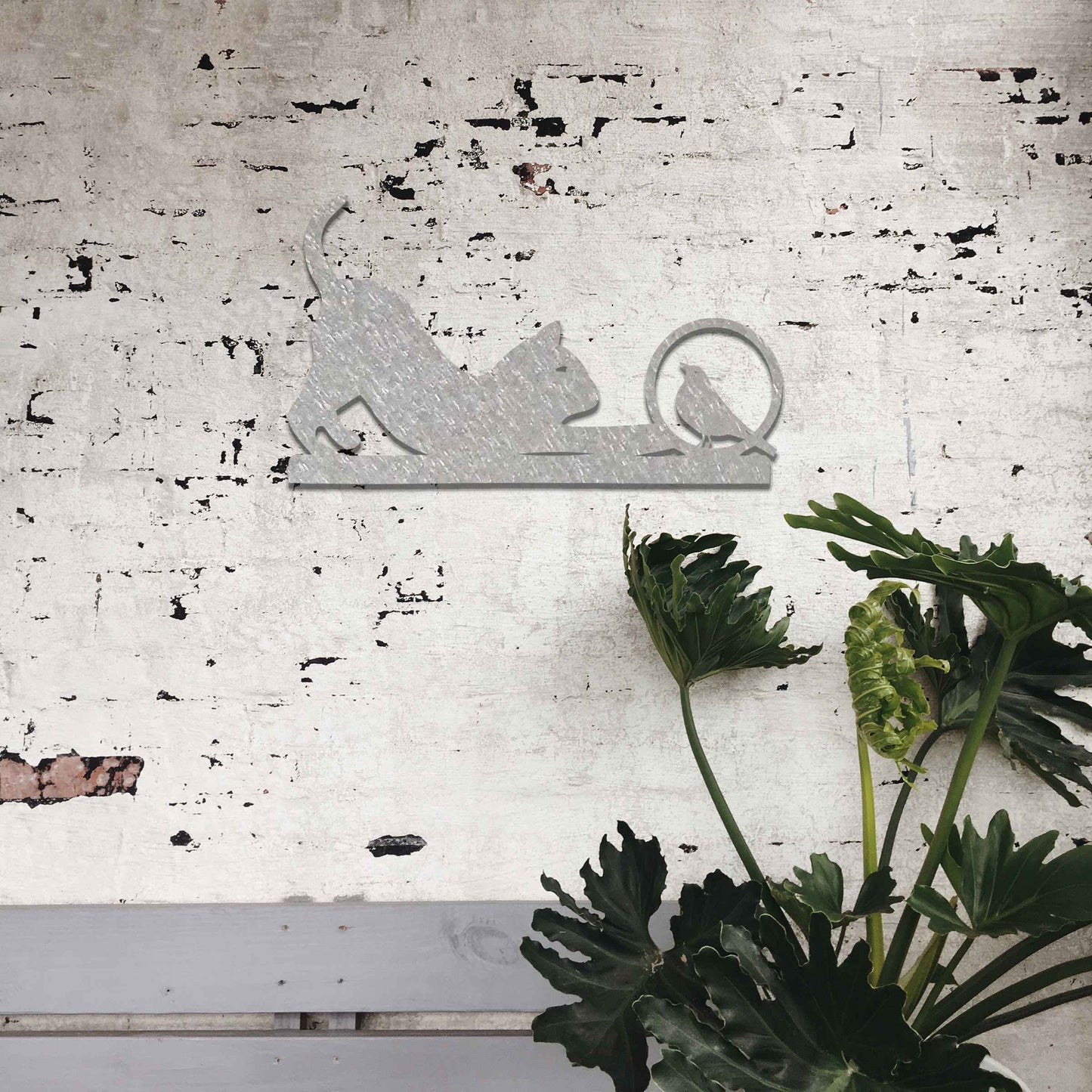 Metal wall art featuring a playful cat crouching in curiosity with a bird perched nearby, perfect for adding a touch of whimsy and nature-inspired charm to your garden, fence, or outdoor decor.