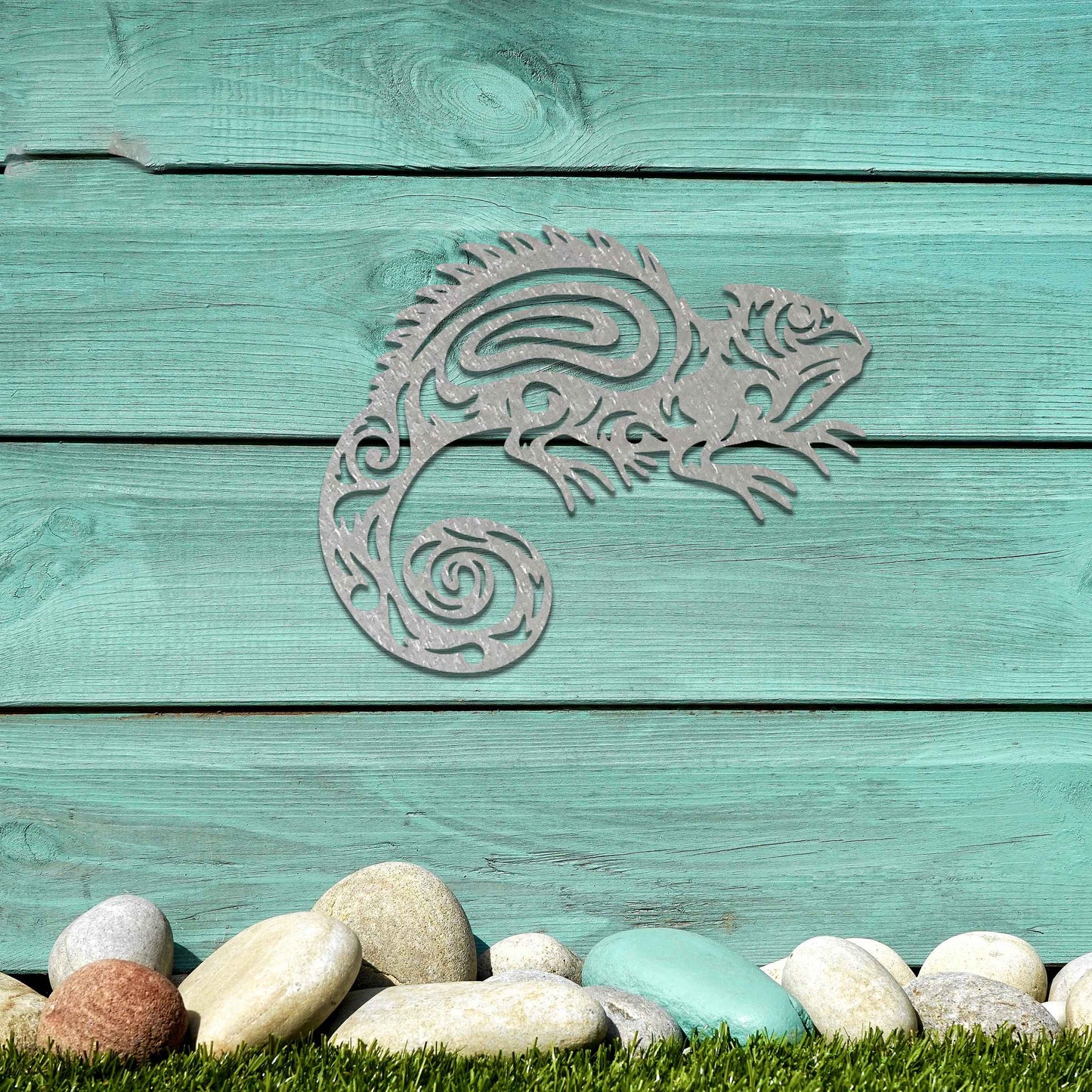 Metal wall decoration featuring a chameleon design with intricate tribal-inspired cutouts, adding an exotic and artistic touch to indoor spaces, displayed on a neutral wall in modern decor.