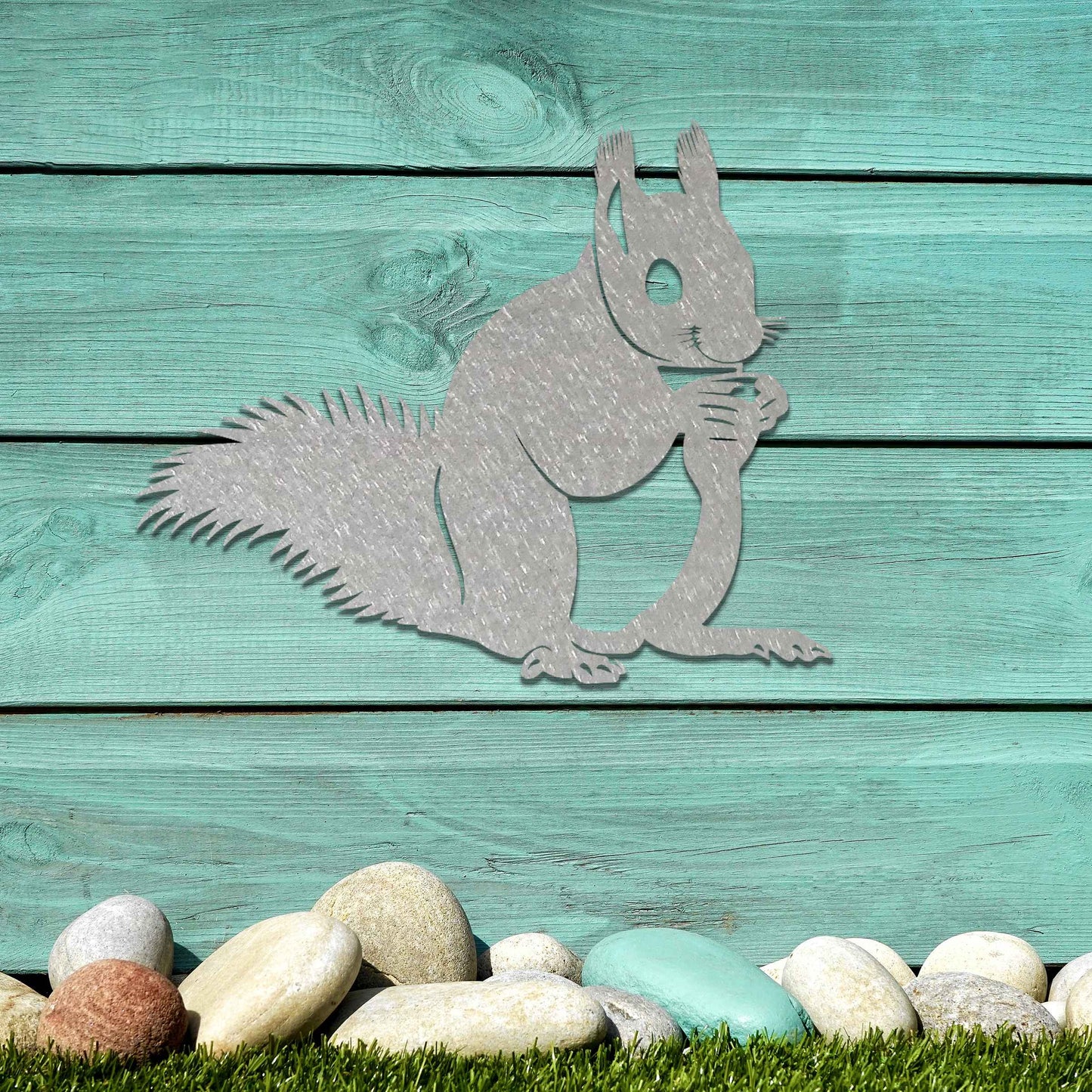 Metal wall decoration featuring a squirrel design with intricate details, adding a playful and artistic touch to indoor spaces, displayed on a neutral wall to highlight its elegant craftsmanship.