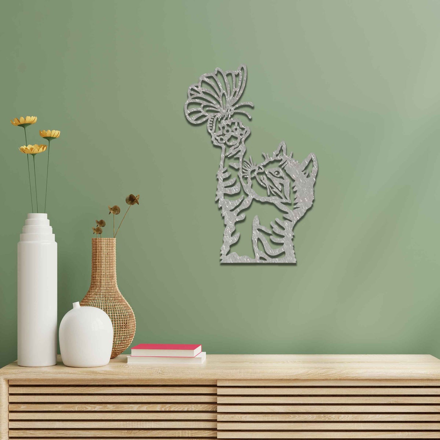 Metal wall art featuring a curious kitten playfully reaching for a butterfly, adding a delightful touch of charm and whimsy to modern indoor or outdoor decor, displayed on a neutral wall.
