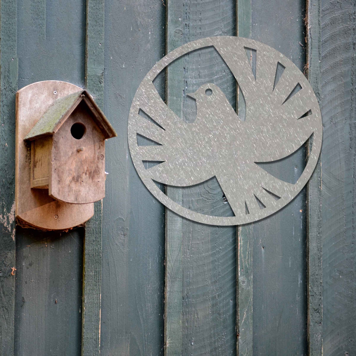 Metal garden decoration featuring a dove silhouette within a circular frame, crafted with minimalist yet elegant detailing, symbolising peace and adding a refined artistic touch to outdoor walls or fences.