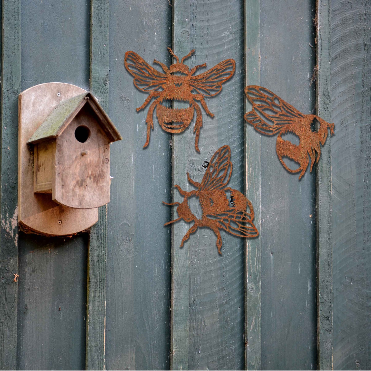 Set of metal garden decorations featuring three detailed bee designs, each showcasing intricate wing and body patterns, perfect for adding a playful and nature-inspired touch to outdoor spaces or fences.