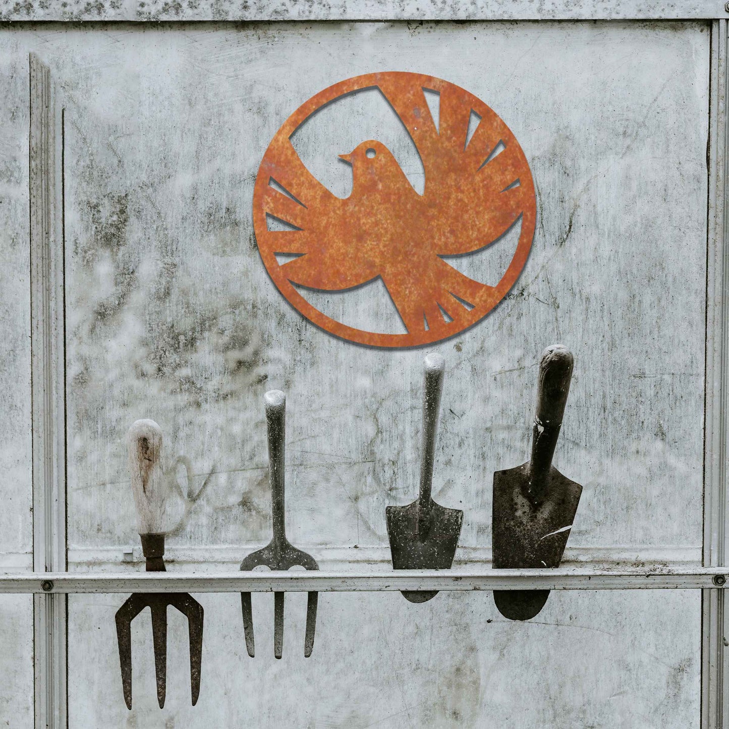 Metal garden decoration featuring a dove silhouette within a circular frame, crafted with minimalist yet elegant detailing, symbolising peace and adding a refined artistic touch to outdoor walls or fences.