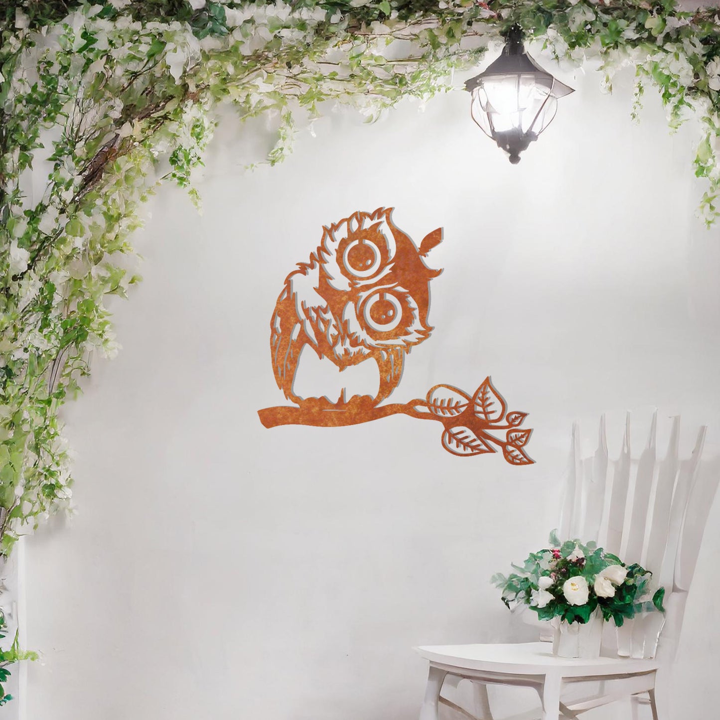A delightful metal wall art design featuring a whimsical owl perched on a branch with intricate detailing of its feathers and expressive eyes, adding a playful and nature-inspired touch to any setting.