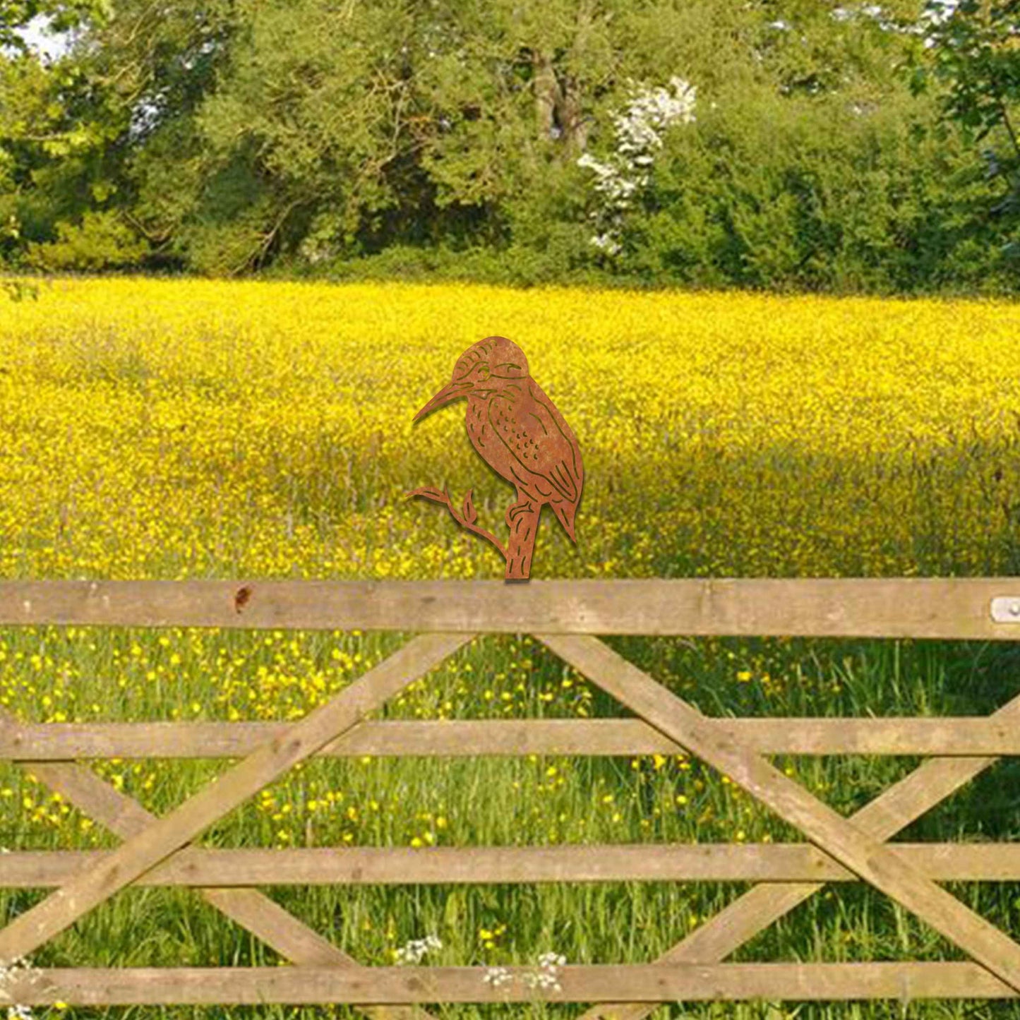 Metal garden decoration featuring a kingfisher silhouette perched on a branch, crafted with a rustic finish, designed to sit atop fences or garden posts, adding a natural and artistic accent to outdoor spaces.