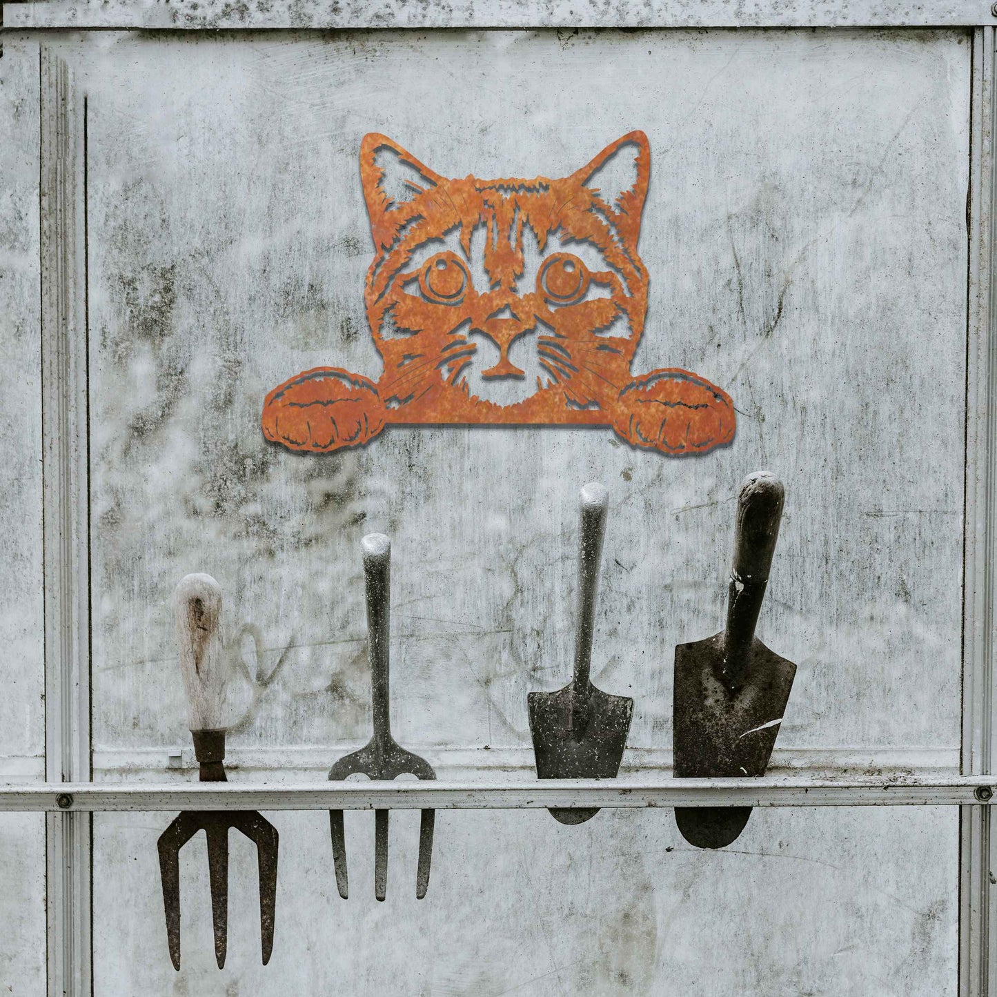 A charming metal wall art piece featuring an adorable cat peeking over a surface, its wide eyes and paws reaching out, adding a playful and endearing touch to modern home decor.