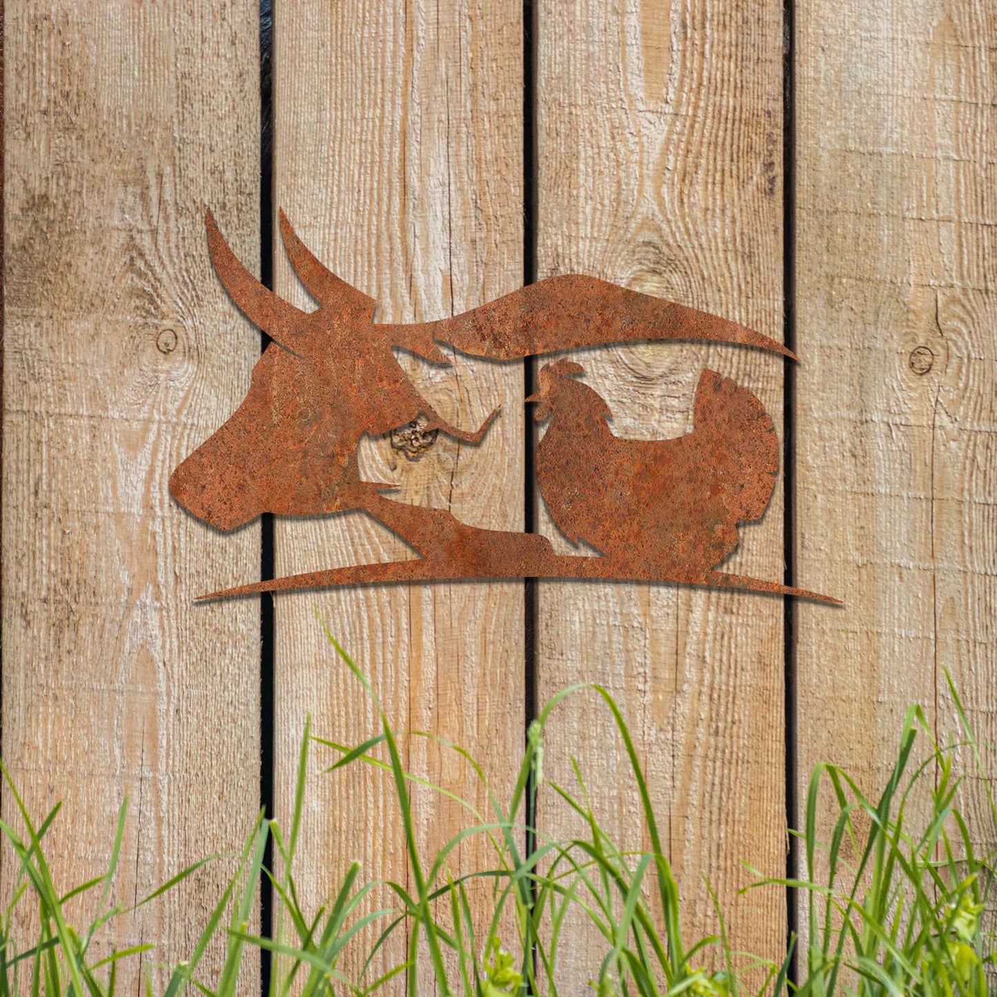 The artwork features a cow, a pig, and a chicken, arranged in a fluid, minimalist design. The cow's head with its distinctive horns forms one part of the composition, followed by the pig and chicken, creating a harmonious flow between the animals.