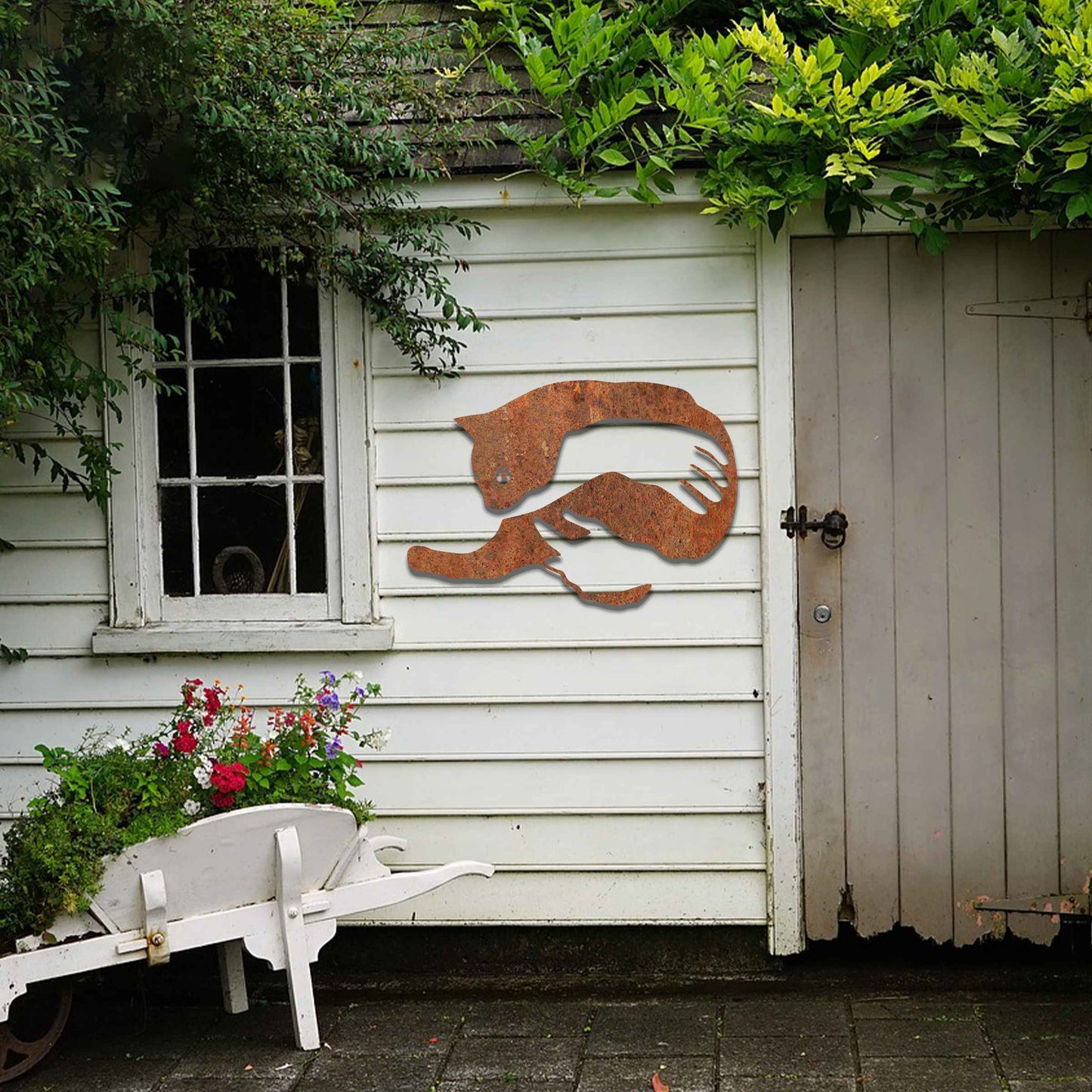 Metal wall art featuring a minimalist silhouette of a cat being gently held by a pair of hands. A striking and heartwarming design that adds an artistic and cosy touch to any modern or contemporary space.