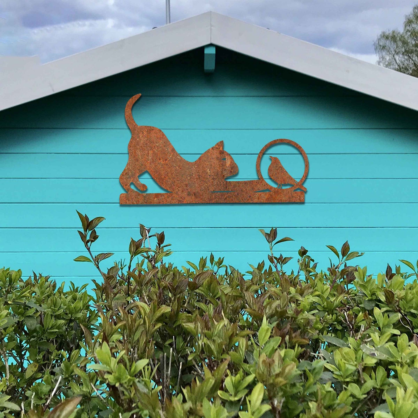 Metal wall art featuring a playful cat crouching in curiosity with a bird perched nearby, perfect for adding a touch of whimsy and nature-inspired charm to your garden, fence, or outdoor decor.