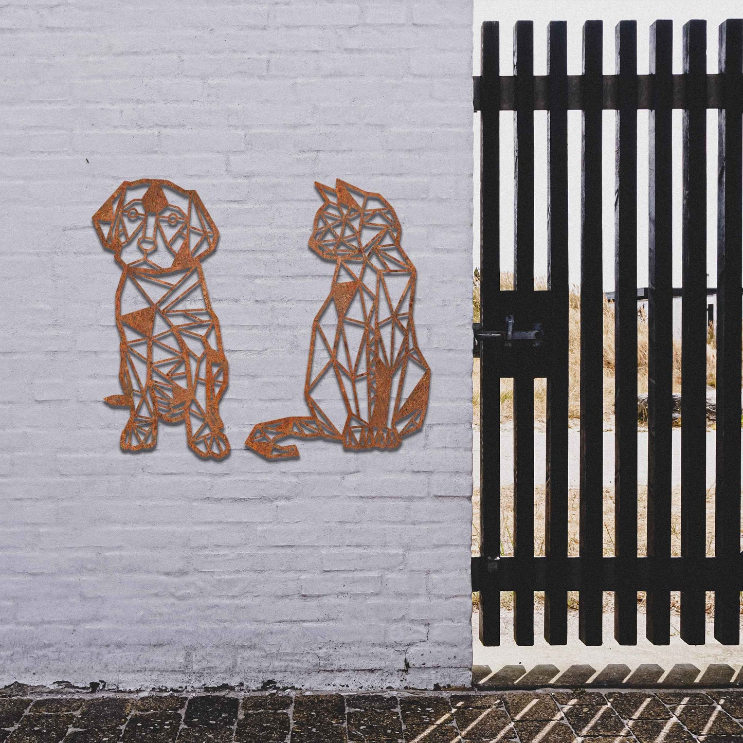 This image displays geometric-style black metal art featuring a dog and a cat, placed side by side. The angular, modern design of the animals contrasts beautifully with the natural greenery around, offering a stylish touch to the surrounding space.