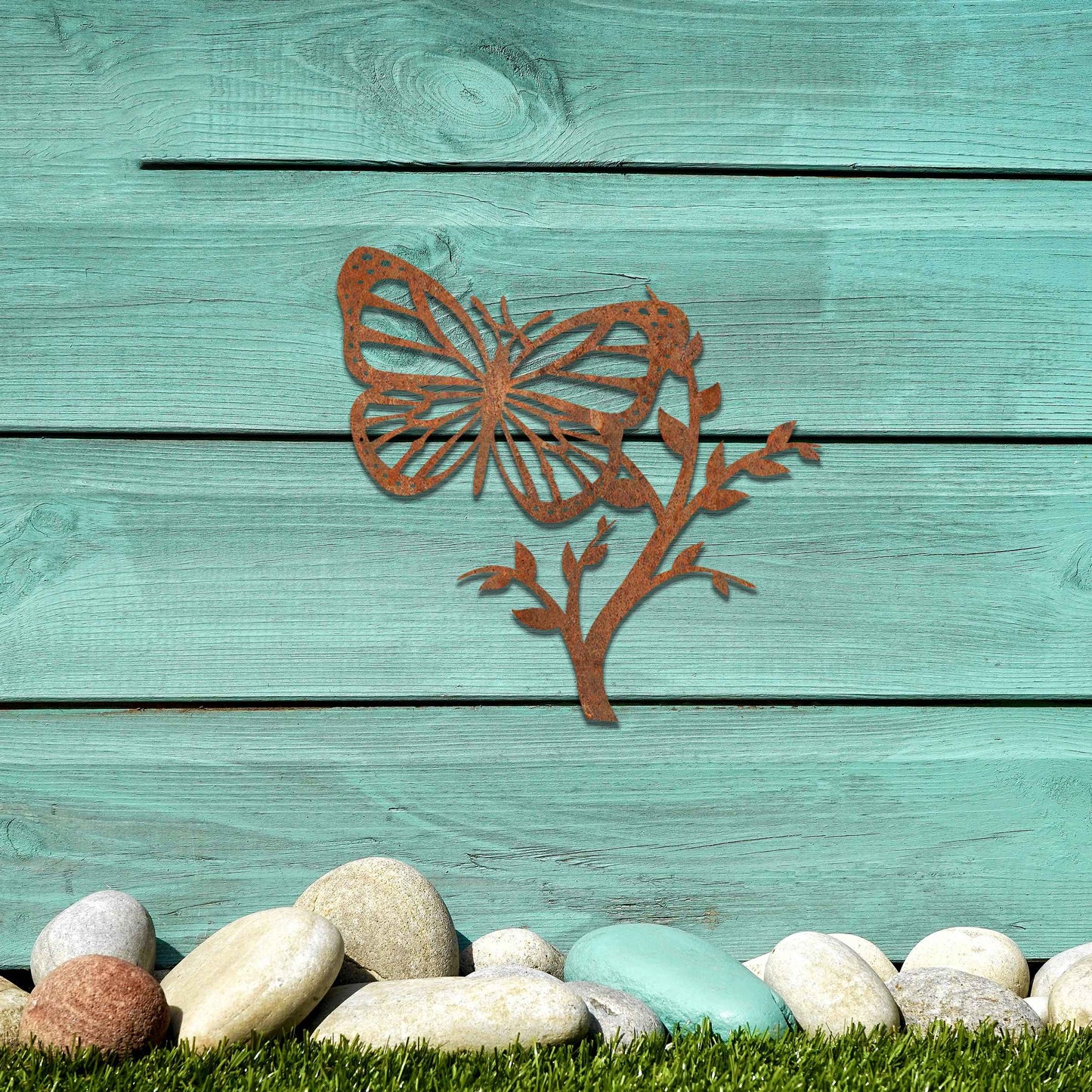 Metal garden decoration featuring a butterfly resting on a leafy branch, crafted with intricate detailing to bring a touch of nature-inspired elegance and charm to outdoor walls or garden settings.