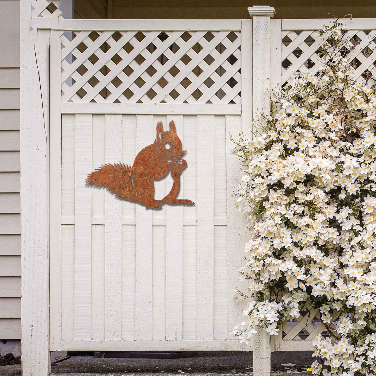 Metal wall decoration featuring a squirrel design with intricate details, adding a playful and artistic touch to indoor spaces, displayed on a neutral wall to highlight its elegant craftsmanship.