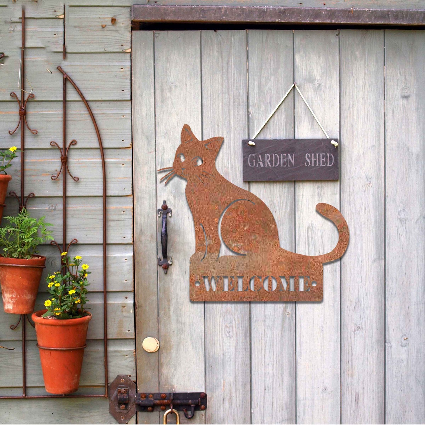 Metal garden decoration featuring a sleek sitting cat silhouette with a personalised address plaque, combining practicality with artistic charm for outdoor walls, fences, or gates.