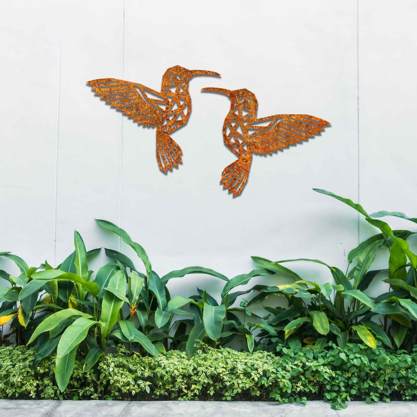 Metal garden decoration featuring two hummingbirds with geometric patterns in a dynamic pose, intricately designed to add elegance and a nature-inspired artistic touch to outdoor walls, fences, or garden sheds