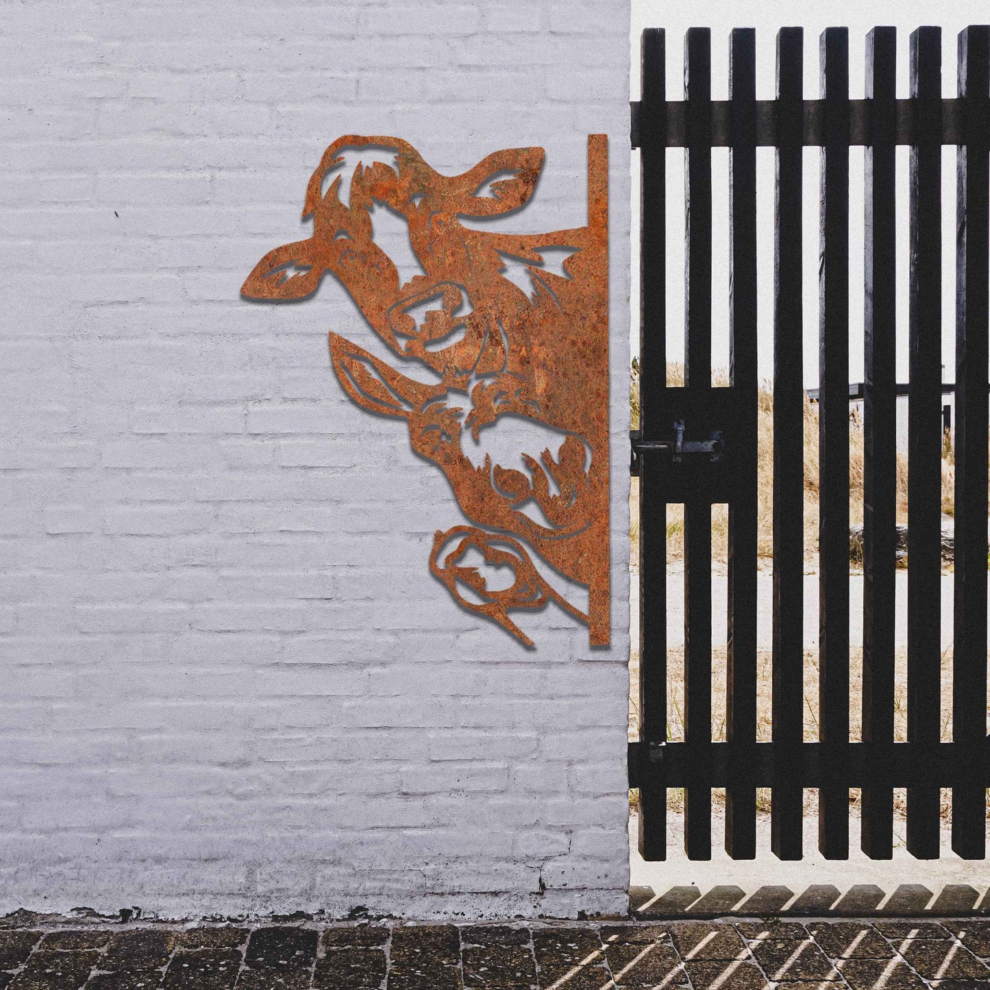 Metal decoration featuring a cow, a donkey, and a goose peeking around a vertical edge, crafted with intricate cutout details and a rustic finish, adding a whimsical and rustic charm to outdoor or garden spaces.