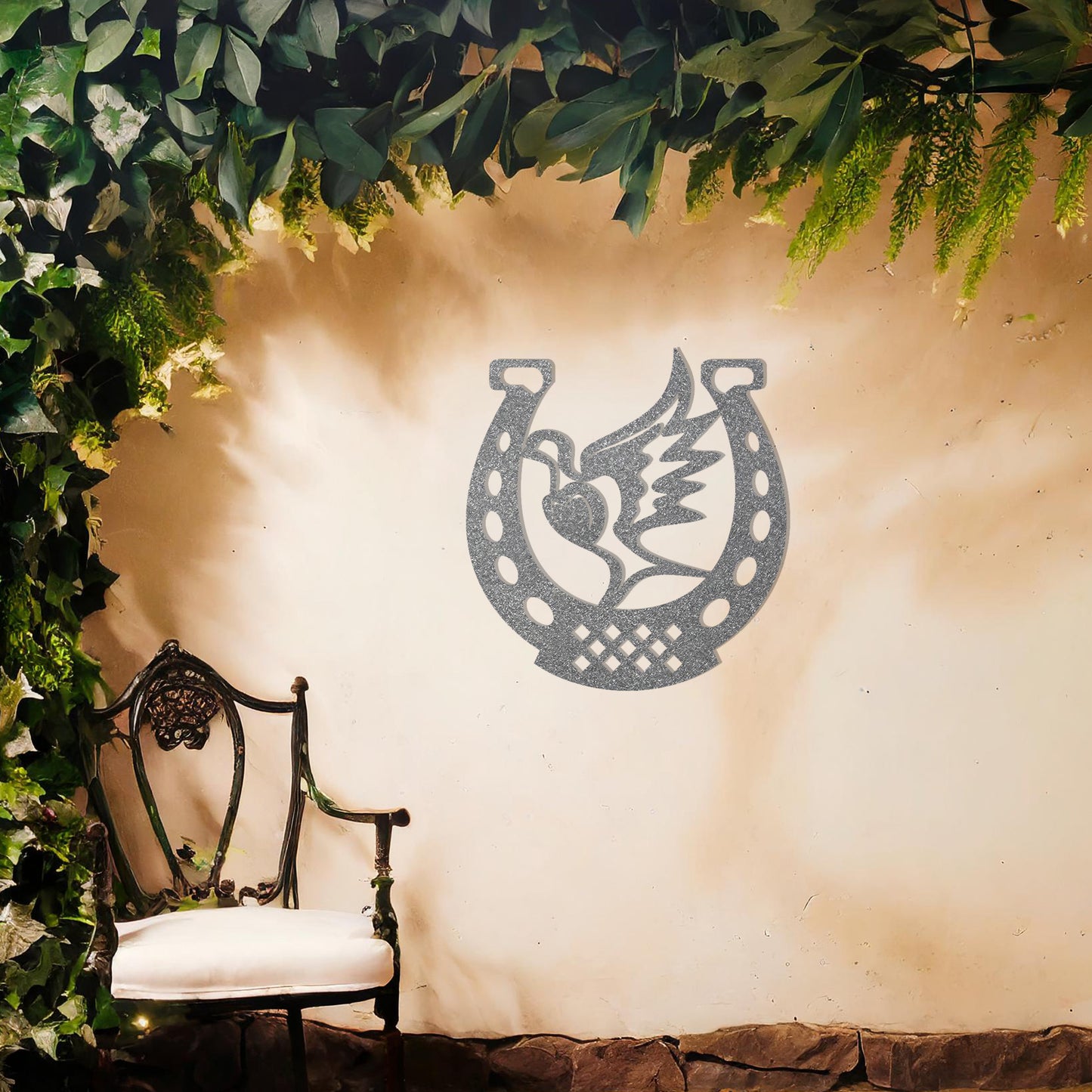 This wall art features a horseshoe design with a dove in flight carrying a heart at its center, symbolising peace and luck. A meaningful and stylish addition to any space with its intricate details and balanced composition.