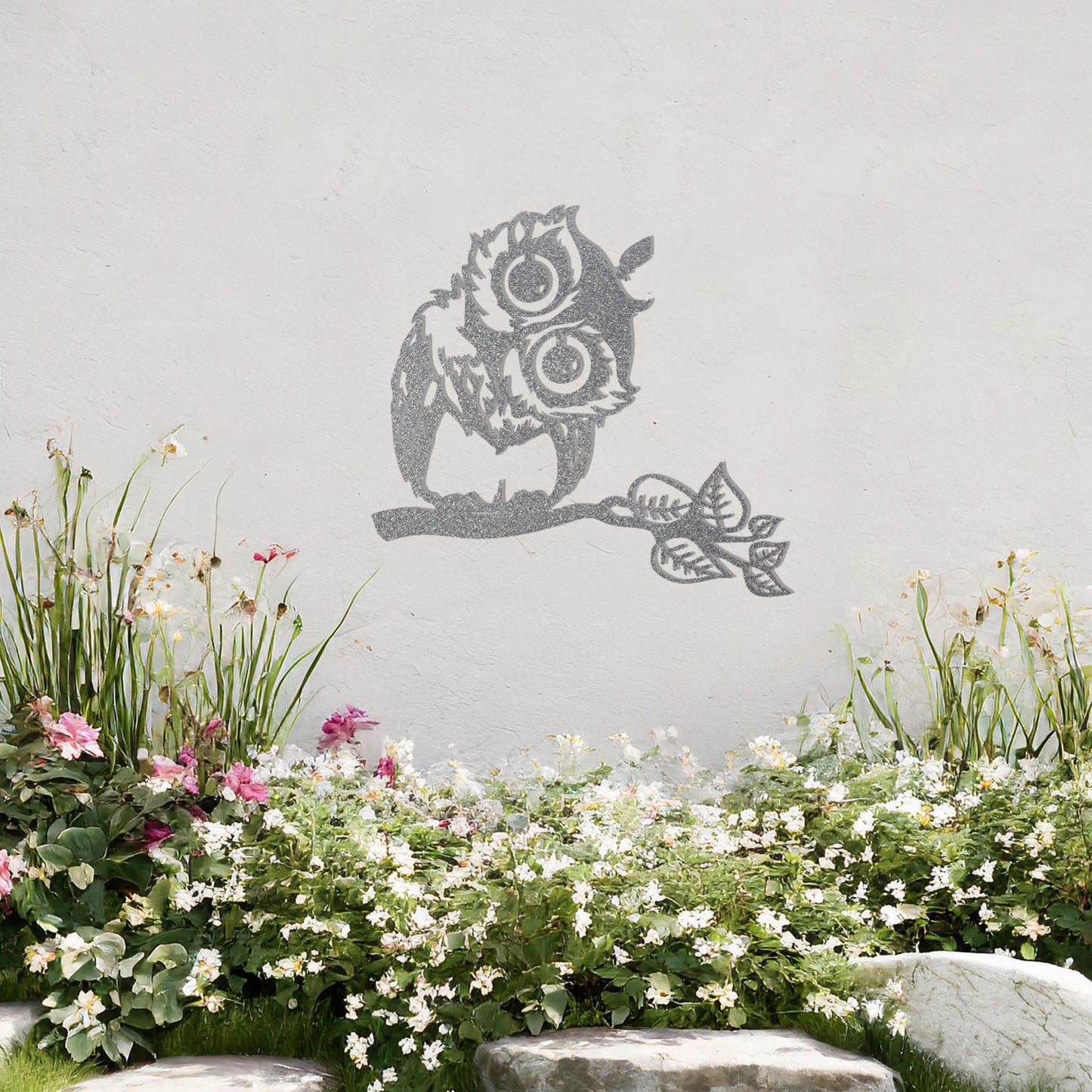 A delightful metal wall art design featuring a whimsical owl perched on a branch with intricate detailing of its feathers and expressive eyes, adding a playful and nature-inspired touch to any setting.
