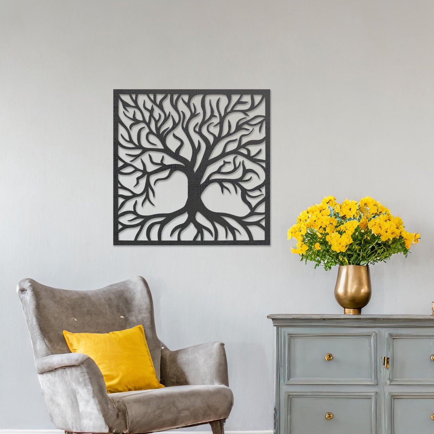 A square wall art piece depicting an intricate tree with branching limbs and visible roots. The artwork is displayed on a neutral wall in a modern room