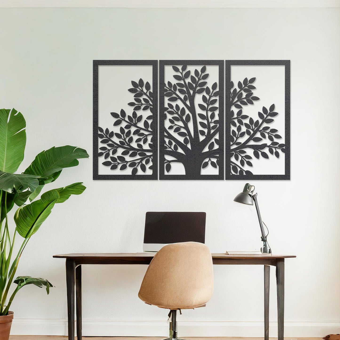 Wooden wall art comprising three panels featuring a tree design with detailed leaves and branches, displayed on a neutral wall within modern room decor, showcasing its intricate and natural craftsmanship.