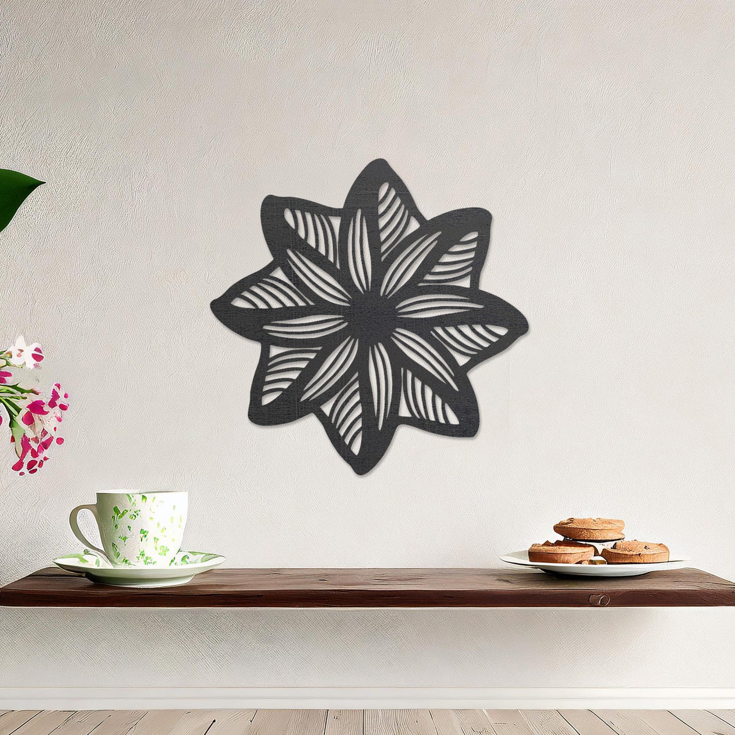 Wall art featuring a star-shaped floral design with layered petals and intricate cut-out patterns. The piece is displayed on a neutral wall within modern decor, adding a unique and decorative focal point to the space.
