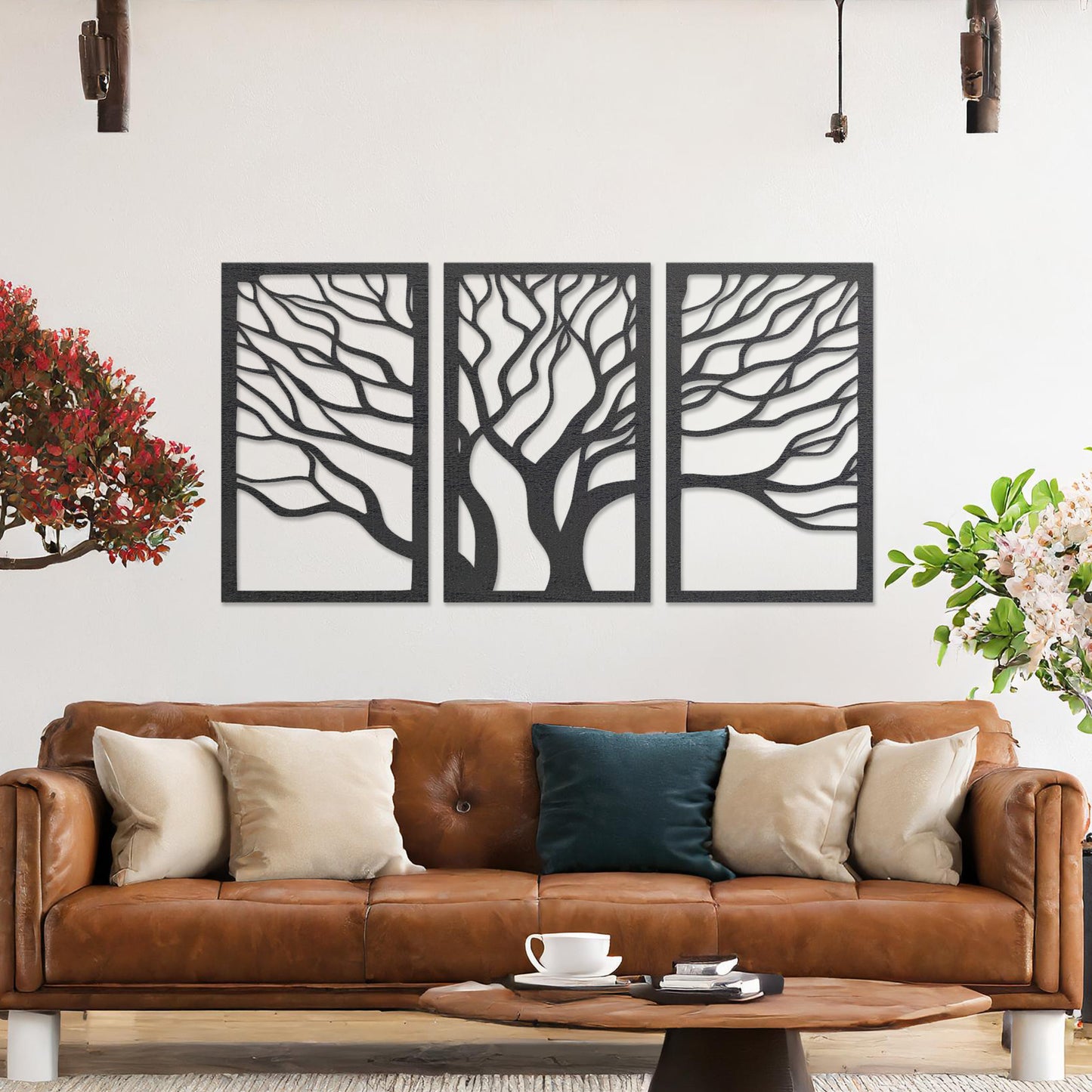 A three-panel wall art featuring a minimalist tree design with flowing, intricate branches. The artwork is displayed on a neutral wall in a modern living room, complementing the contemporary decor and adding a touch of natural elegance.