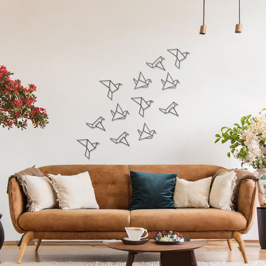 Wooden wall art featuring a flock of geometric bird designs in a scattered arrangement, creating a sense of movement. The artwork is displayed on a neutral wall within modern room decor, highlighting its dynamic and minimalist aesthetic.