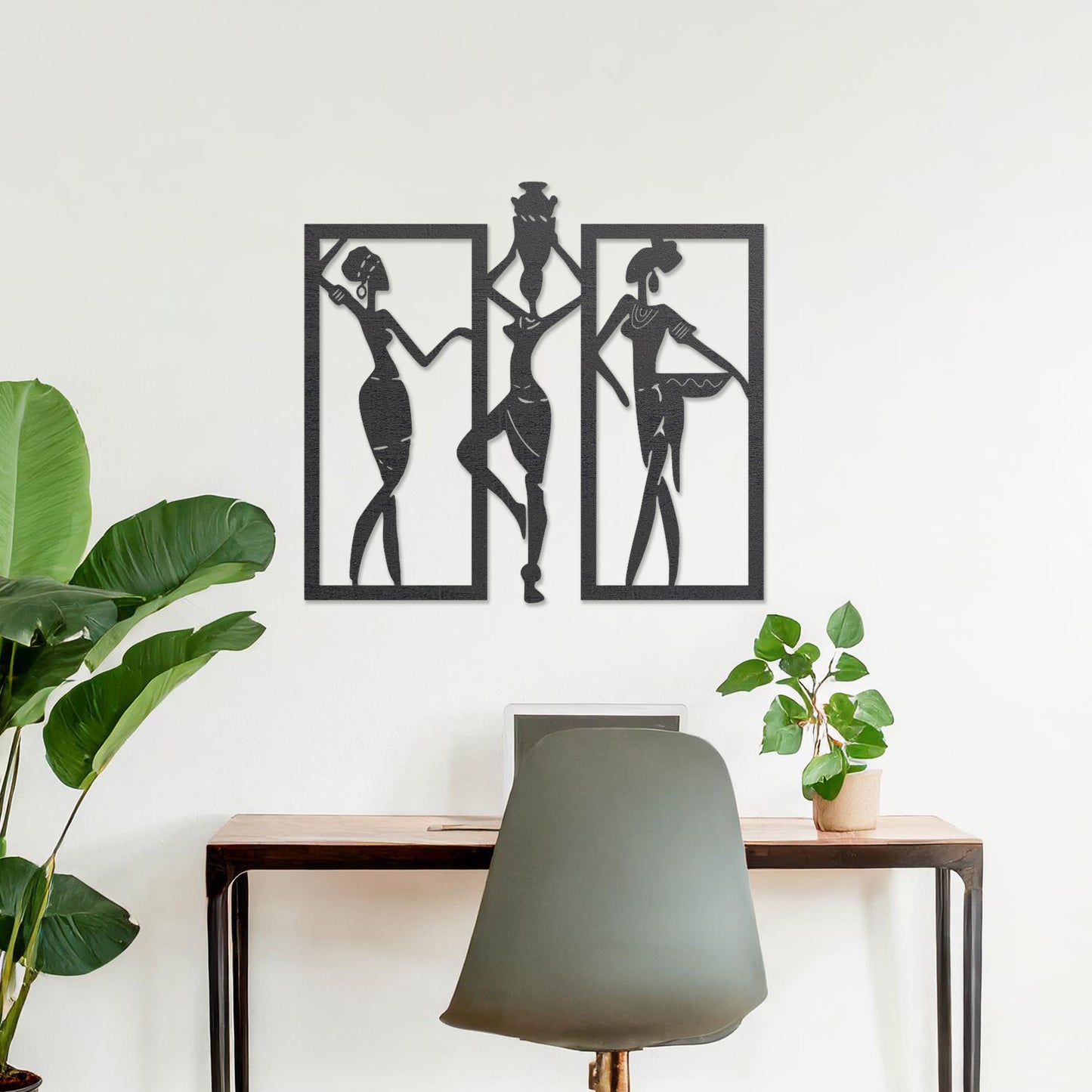 Wall art featuring a triptych design of abstract figures in dynamic poses, framed within rectangular panels. The artwork is displayed on a neutral wall within modern decor, adding an artistic and cultural touch to the space.