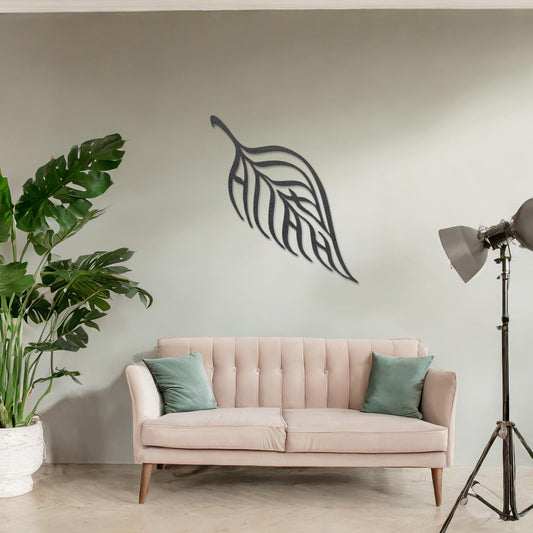 Wooden wall art featuring a single leaf design with elegant, flowing lines and intricate cut-outs. The artwork is displayed on a neutral wall within modern room decor, emphasising its minimalistic and natural aesthetic.