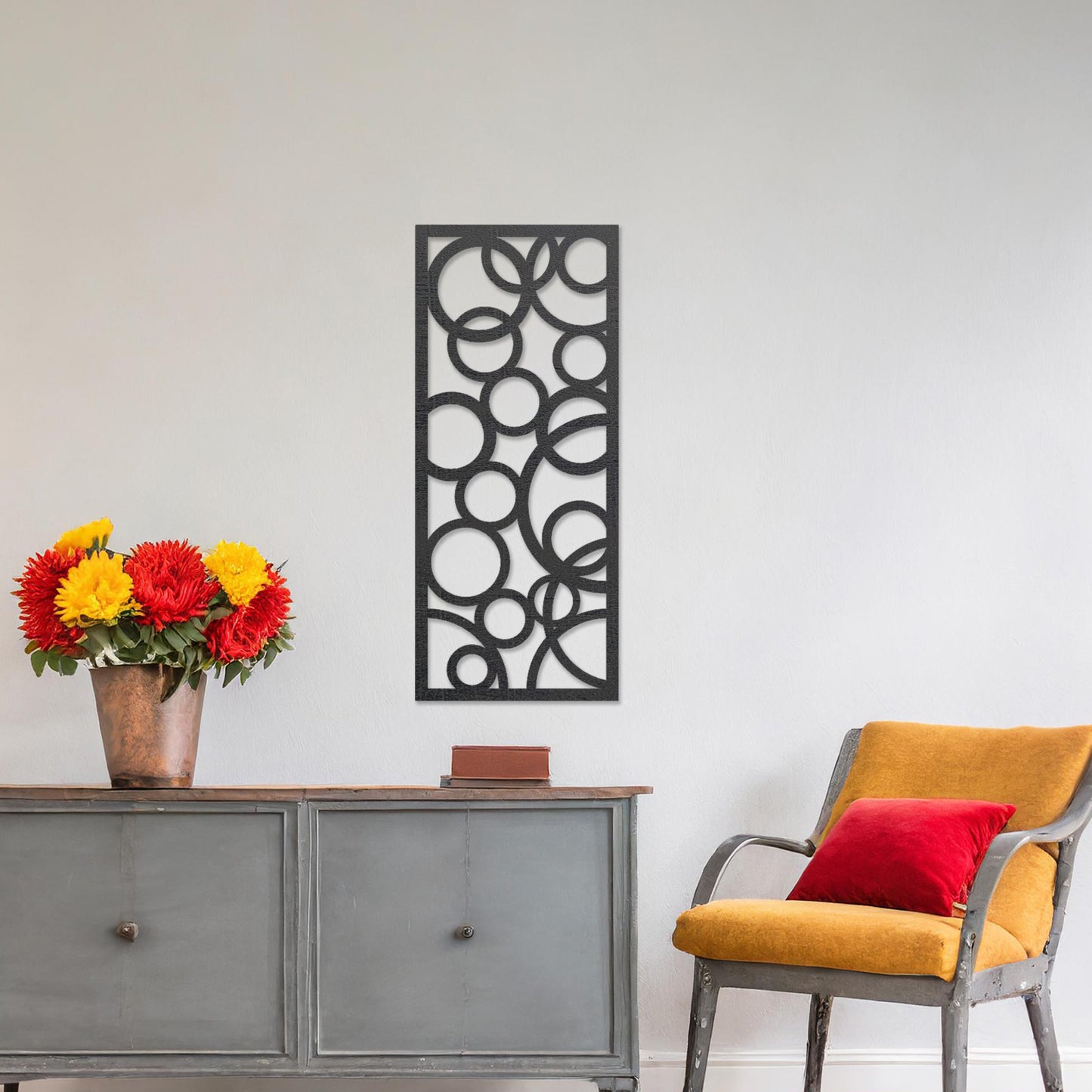 A rectangular wall art piece featuring an abstract design of overlapping circles of various sizes. The artwork is displayed on a neutral wall in a modern room,