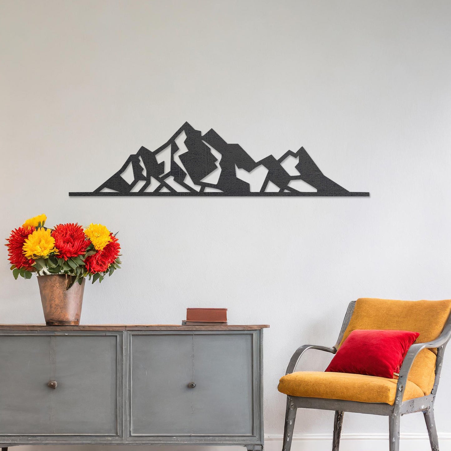 Wall art featuring a minimalist mountain range design with sharp geometric peaks. The piece is displayed on a neutral wall within modern decor, adding a natural and contemporary accent to the space.