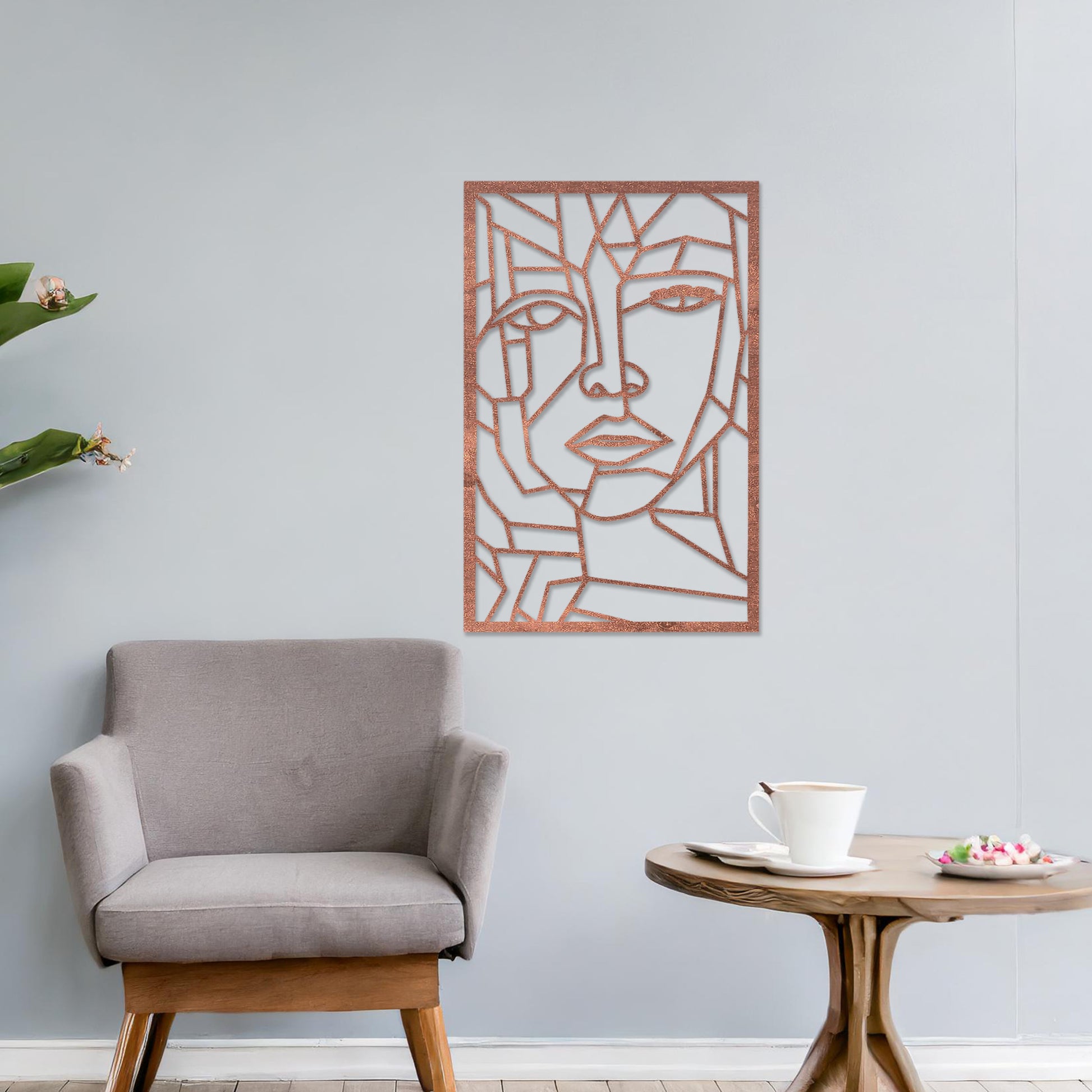 Wall art featuring a geometric abstract face design with sharp angular lines forming a modern and artistic composition. The piece is displayed on a neutral wall within contemporary decor, adding a bold and creative focal point to the space.